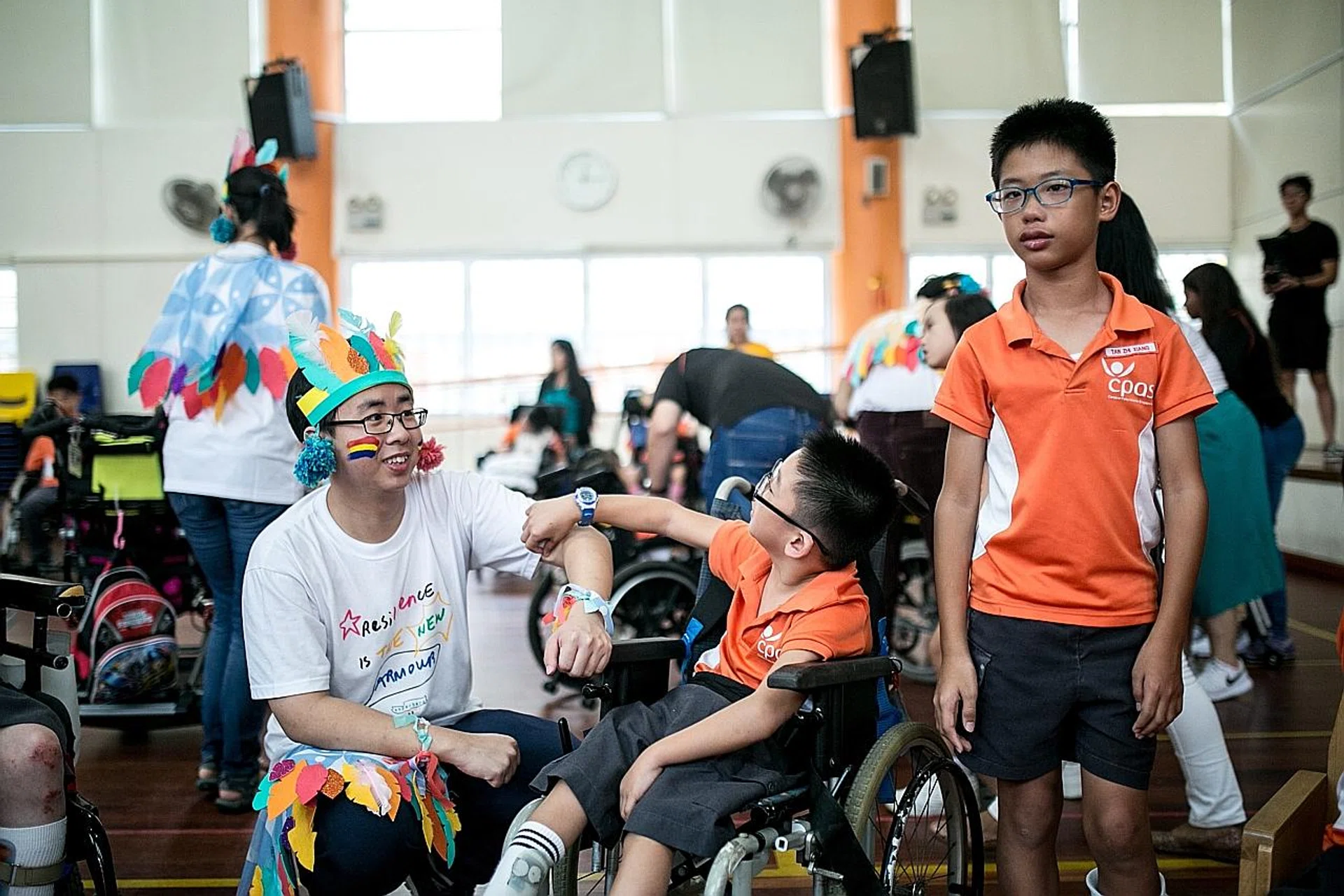 Mr Ng Li Jie (left) has mild autism and was shunned by his polytechnic classmates, so he decided to volunteer at Superhero Me, a ground-up arts movement and non-profit company that fosters inclusion of children with special needs. 