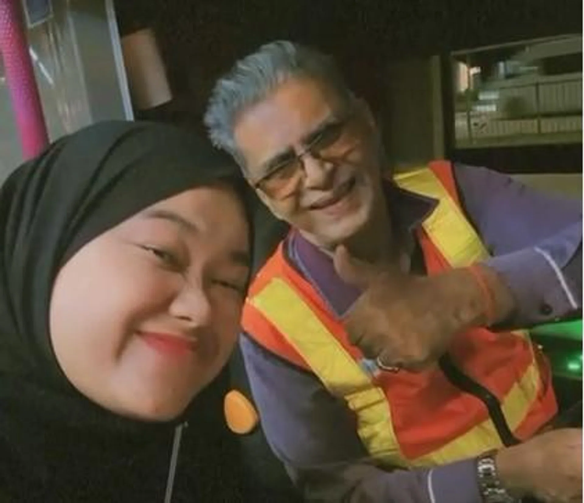 Rini Rindiani with Uncle Rama, who has been working as a bus driver for 27 years.