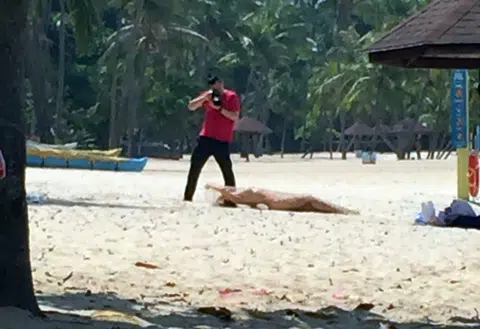 Model stopped while posing nude on Sentosa beach