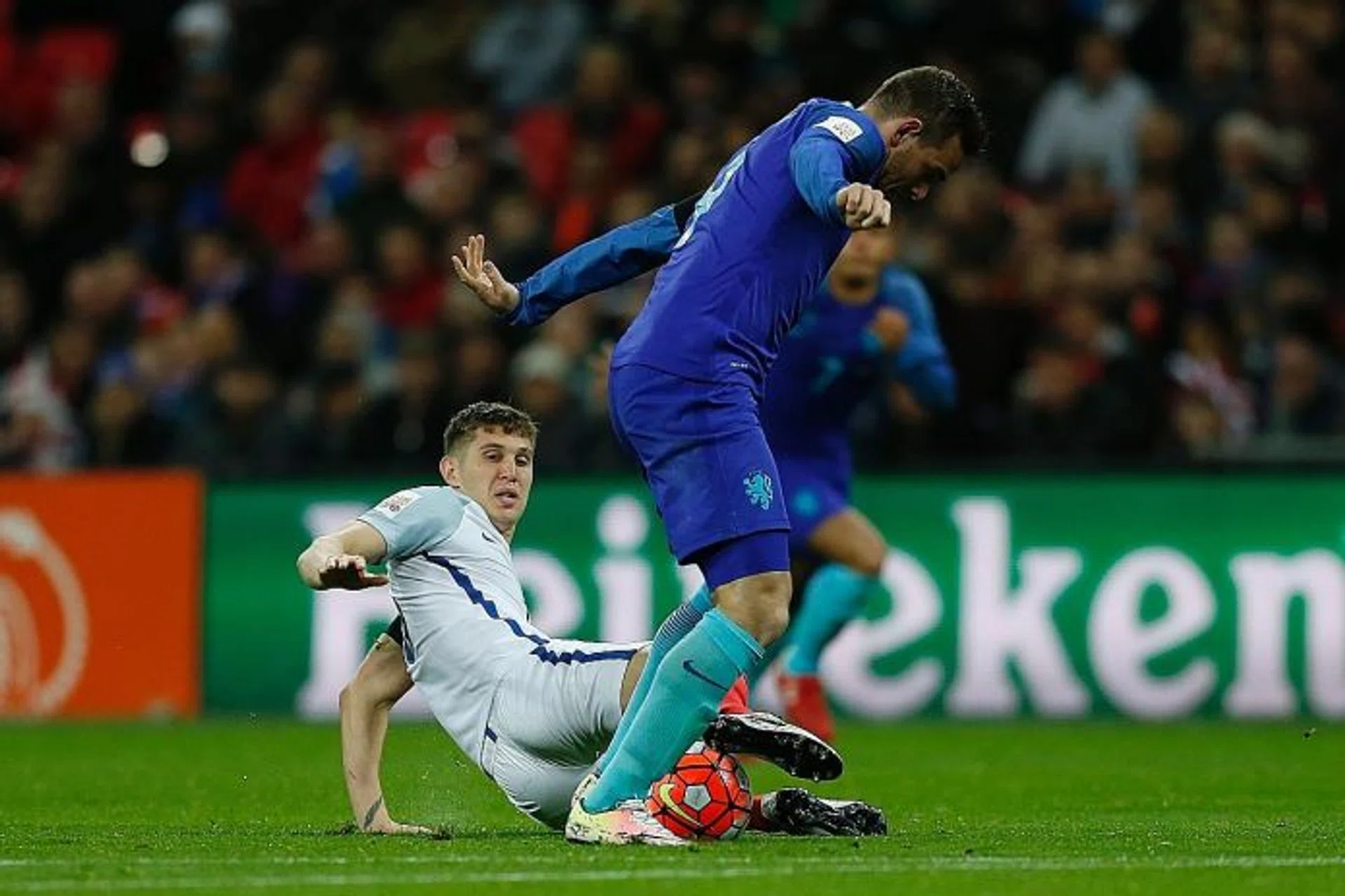 COSTLY ERROR: John Stones (in white) slips in the build-up to a spell of play which results in Holland winning a penalty converted by Vincent Janssen (in blue).