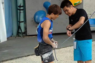 Singaporean official Stanley Yeo scales the summit of sport climbing