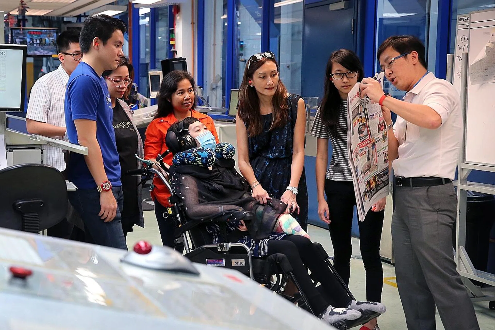 Jameen Chong visiting the Singapore Press Holdings' Print Centre with her helper (in orange), mother (in blue) and sister (in black and white).