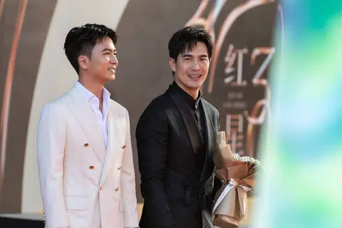 Actors Xu Bin (left) and Pierre Png walking the red carpet at the Star Awards ceremony at Mediacorp on July 6.