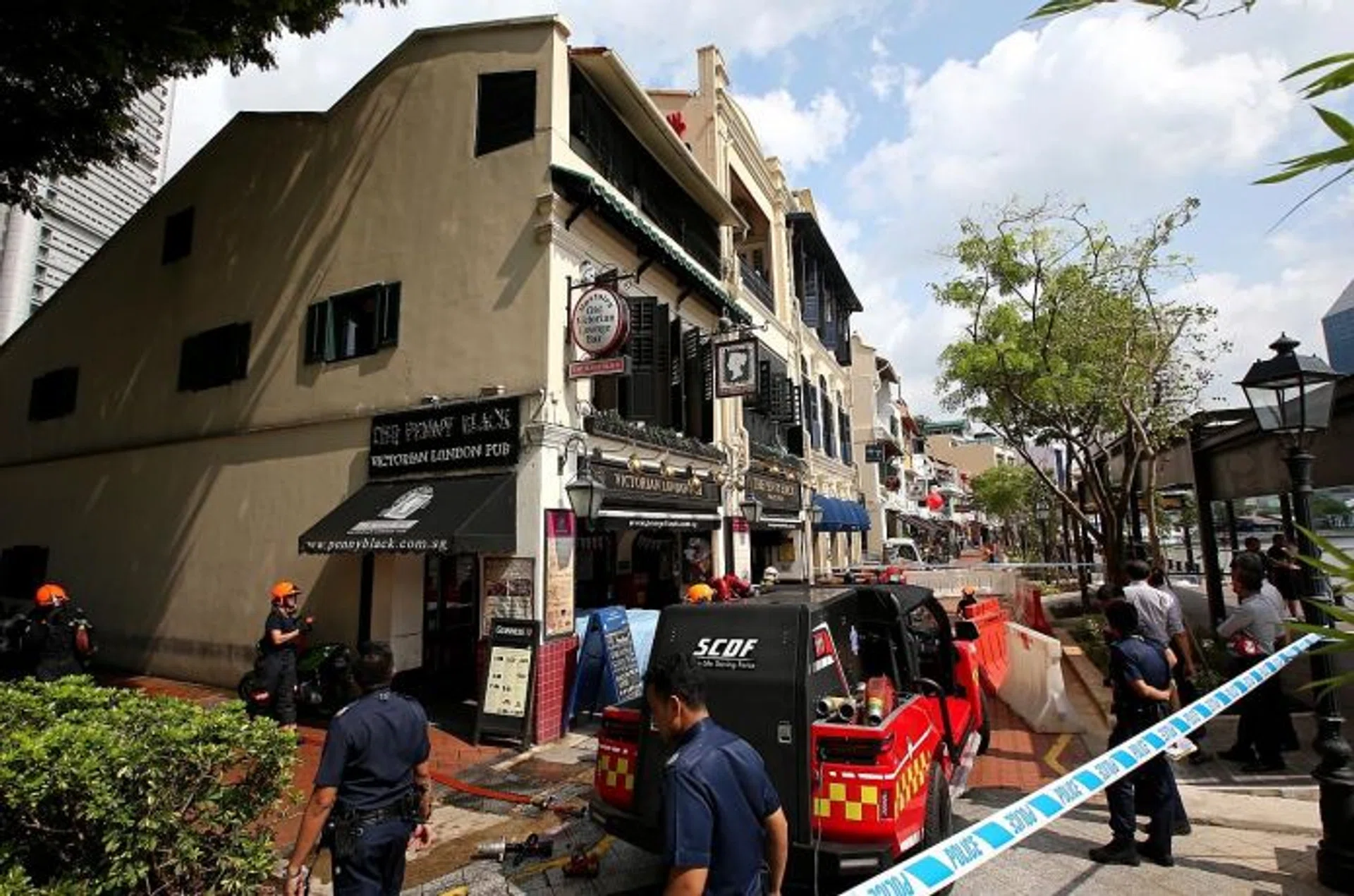 AREA: (Above) Police cordoned off the area around The Penny Black pub after the first fire broke out at its premises at about 10am. 