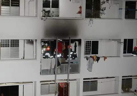 Man in hospital after trying to put out fire in neighbour's flat