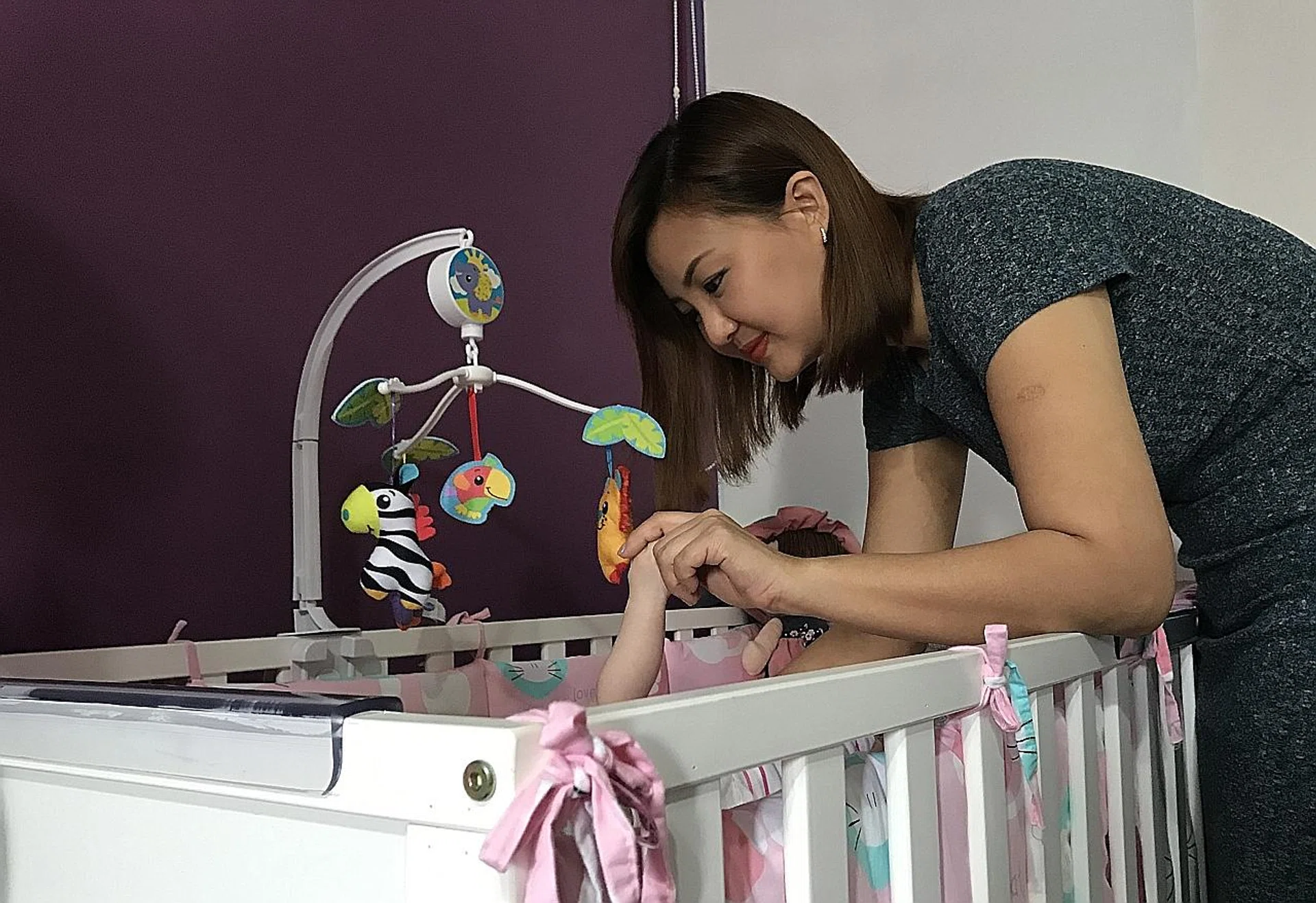 Madam Hazel Sim, who left nursing to be a saleswoman, is now fostering a four-month-old girl and a two-year-old boy. 