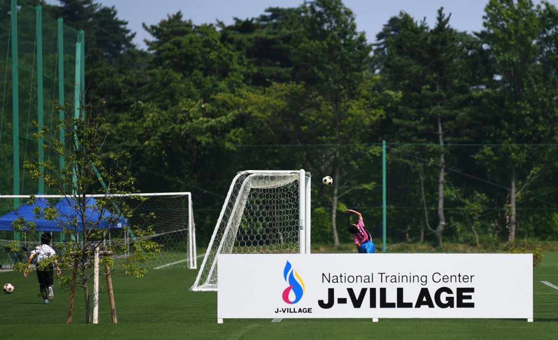 Children play football at the J-Village during a media tour in Naraha, Fukushima prefecture on Aug 2, 2019. 