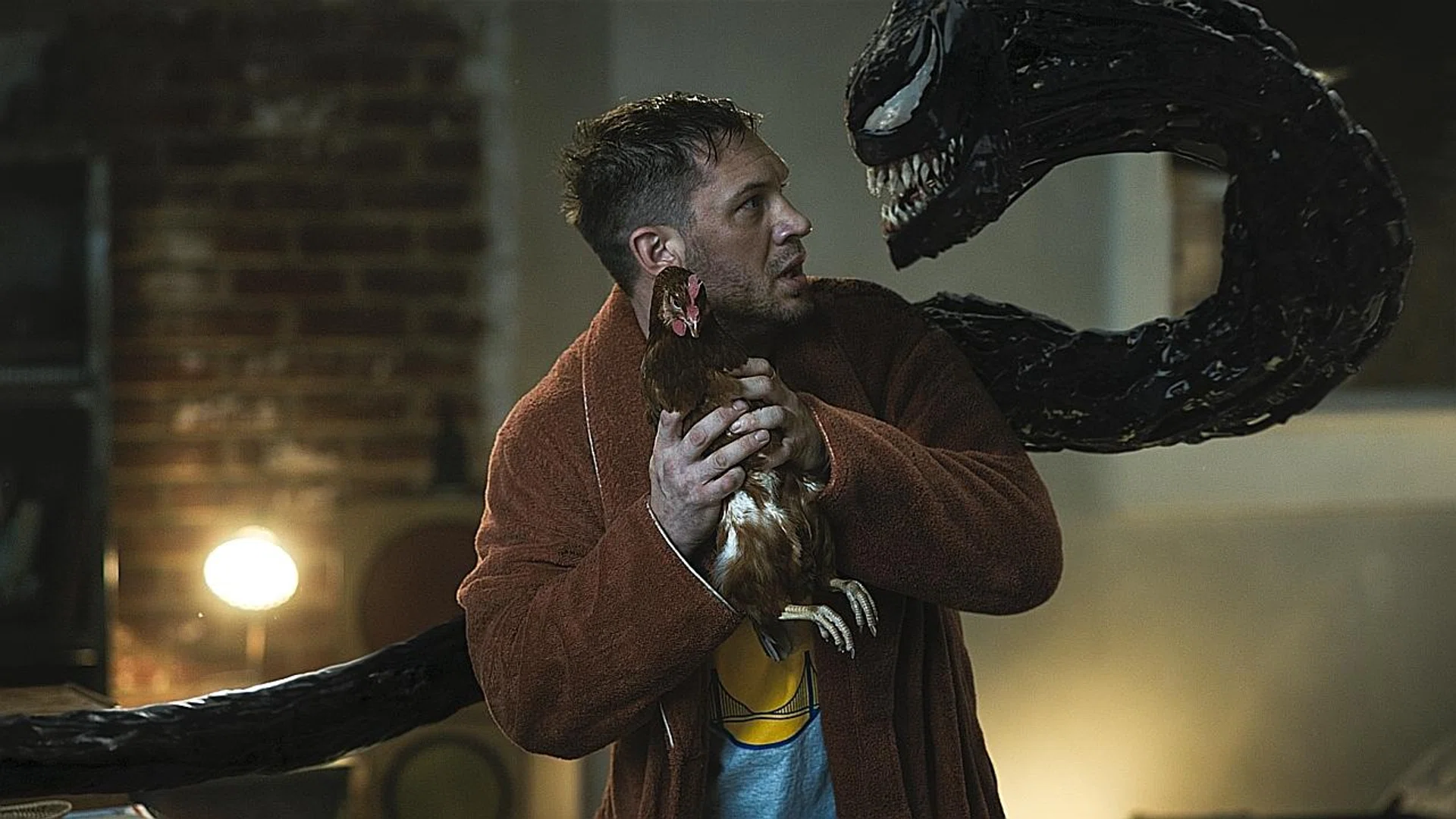 Tom Hardy as Eddie Brock in Venom: Let There Be Carnage, where he battles it out with another menacing symbiote, Carnage. 