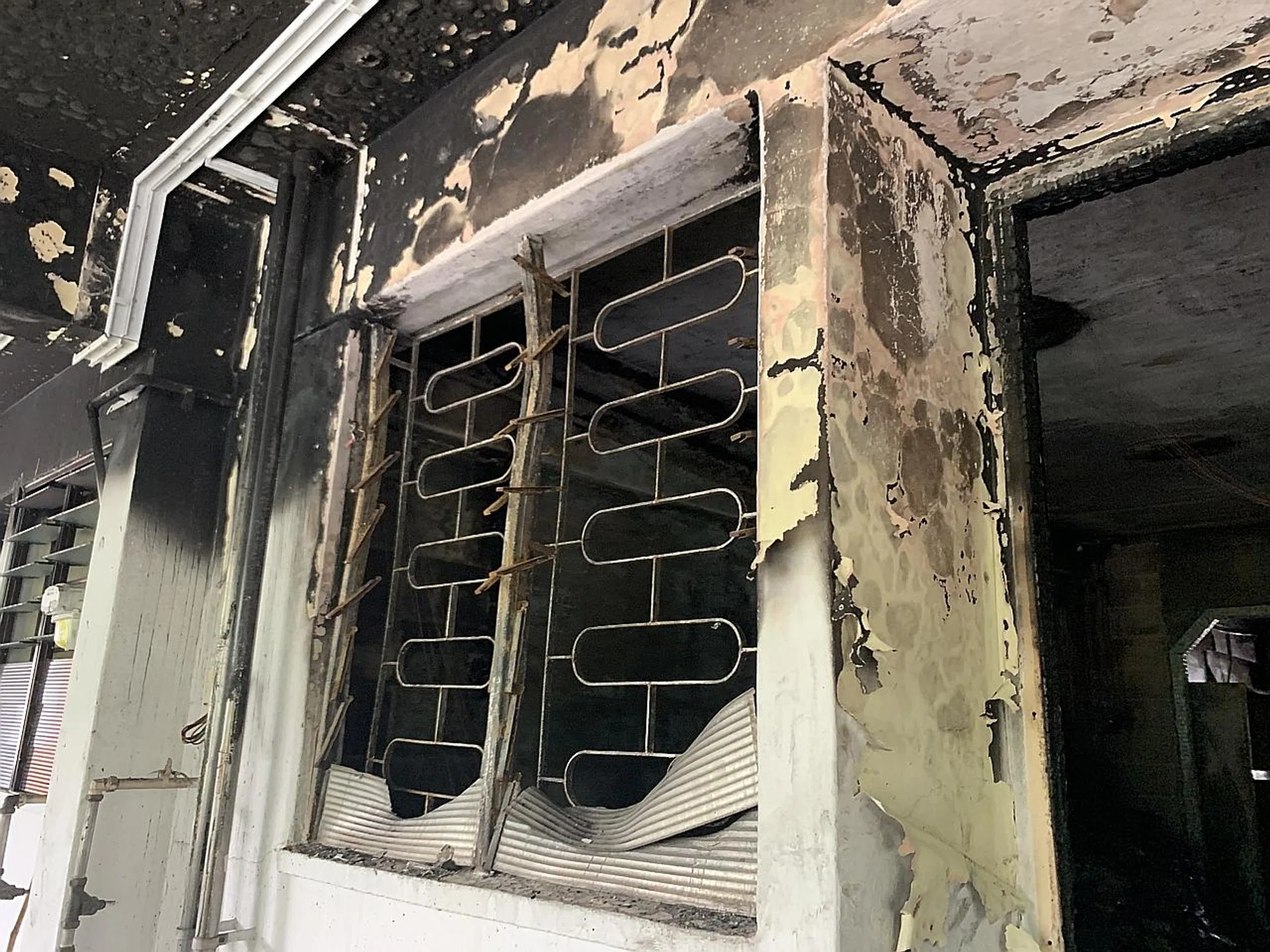 The charred unit at Block 446 Ang Mo Kio Avenue 10 after a fire broke out in the morning. 