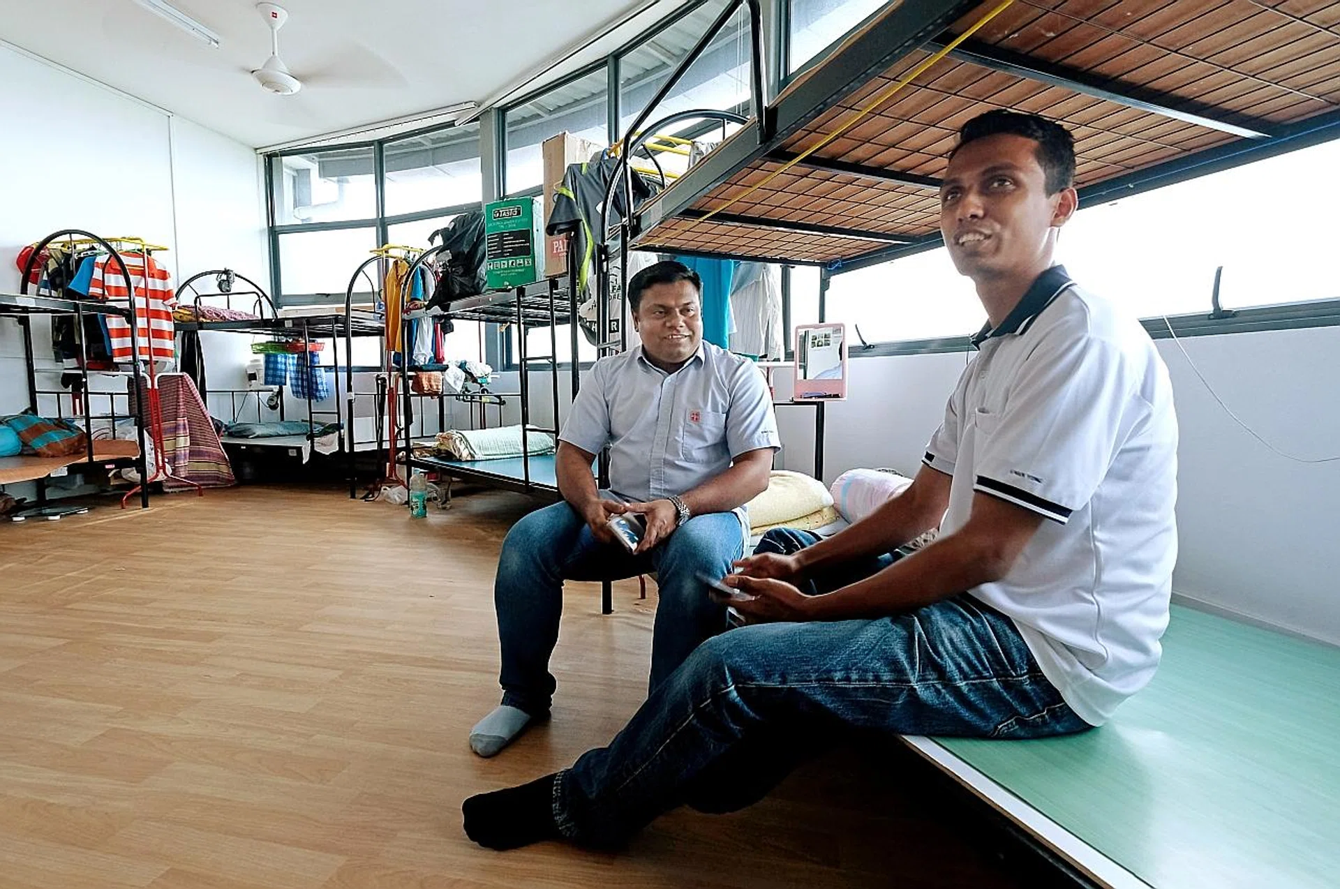 Bangladeshi worker M Selim Montaj Ali (left, with his colleague Mustasizur Rahman) is happy with the living conditions at his current dormitory. 
