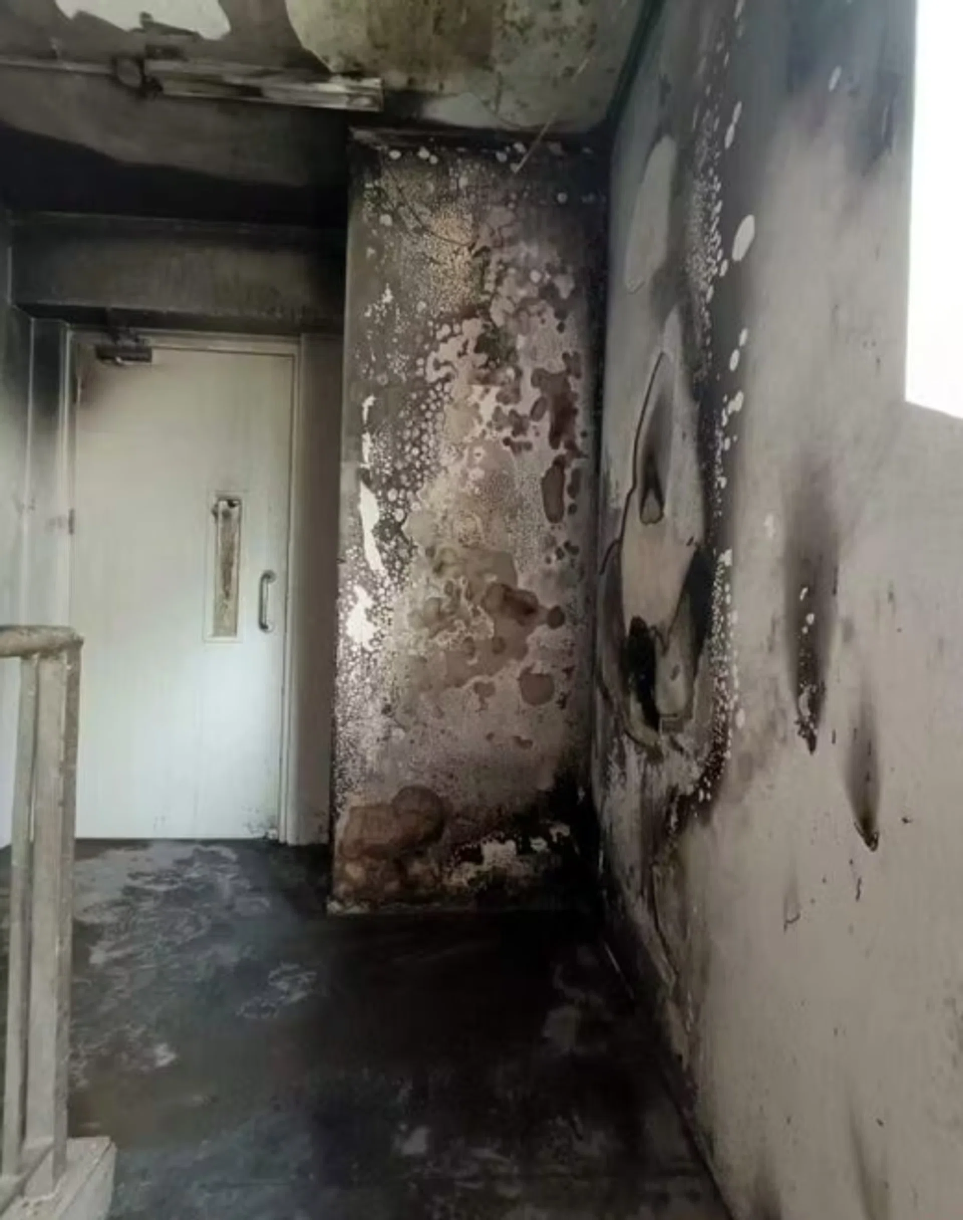 The stairwell of this Yishun HDB block was blackened with soot.