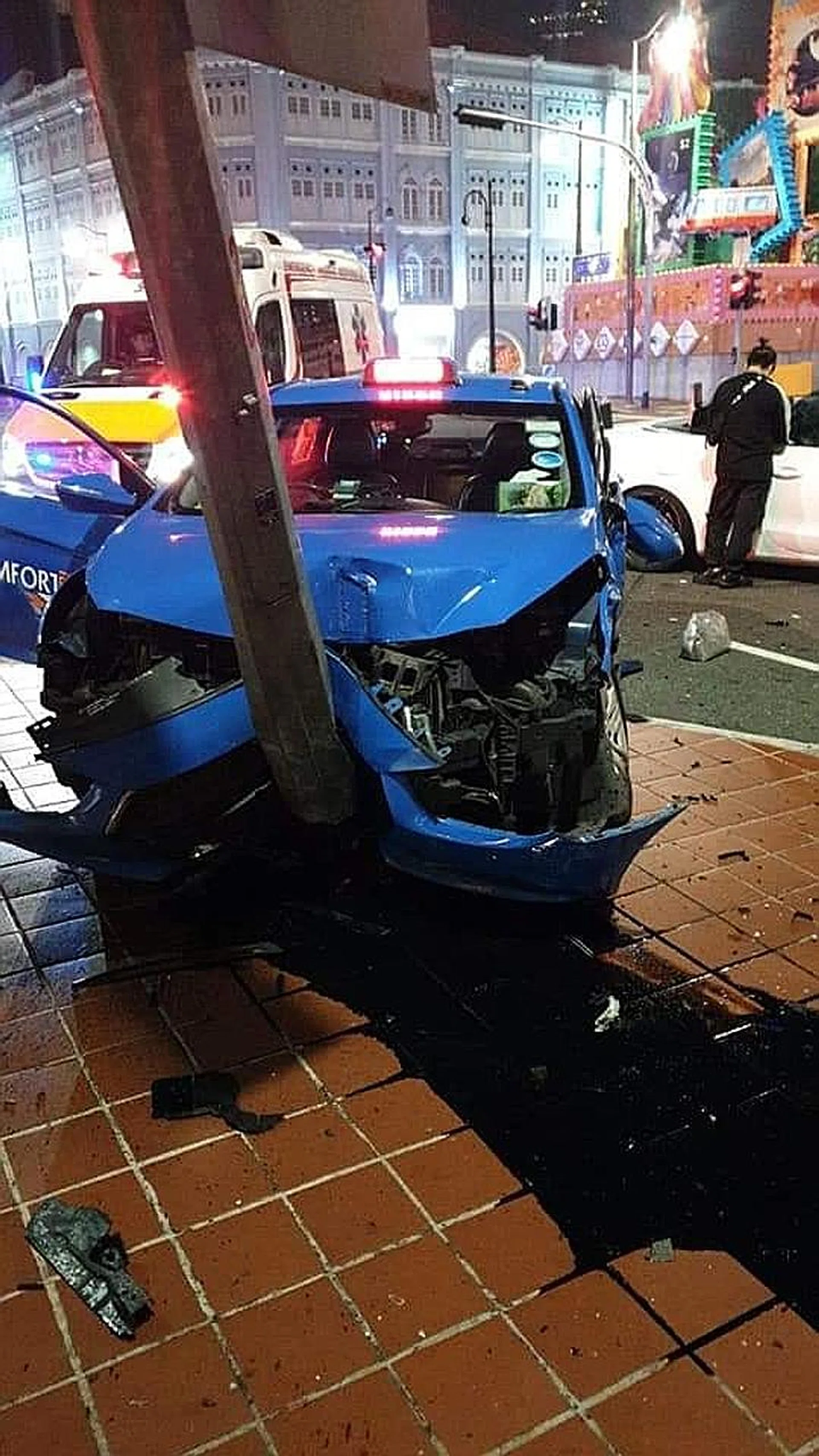 (Above) The taxi crashed into a lamppost at the junction of Eu Tong Sen Street and Upper Cross Street.  