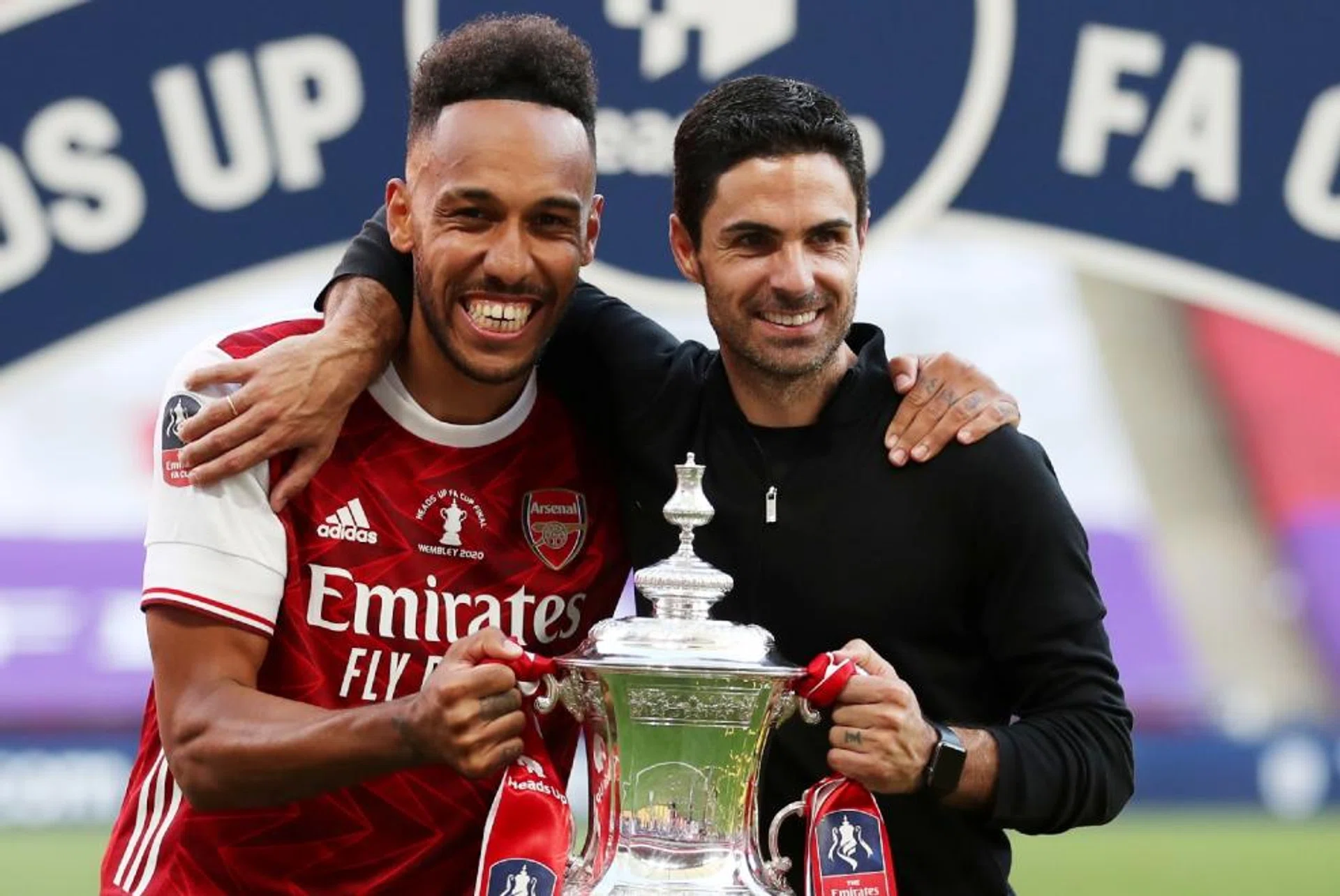 Arsenal striker Pierre-Emerick Aubameyang (left) posing with manager Mikel Arteta, after the Gunners won their 14th FA Cup trophy last season.