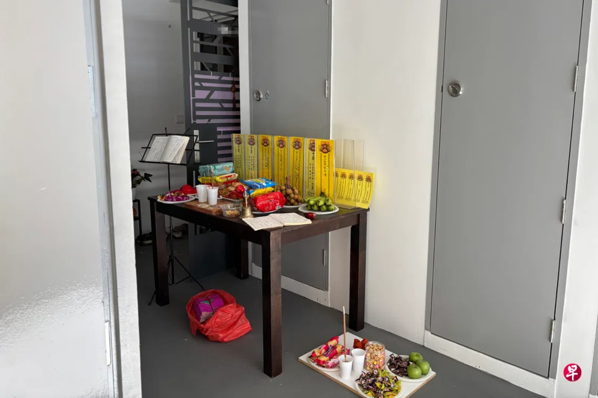The woman placed ritual offerings outside her unit in the shared corridor.