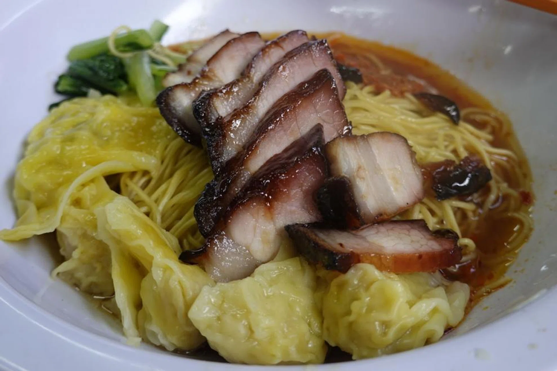 Mr Desmond Tan and partner Marcus Leow at their stall preparing their version of wonton mee (above). Also popular at the food centre are the roasted duck from Choon Kee Roasted Delights and the prawn vadais at The Original Vadai. 