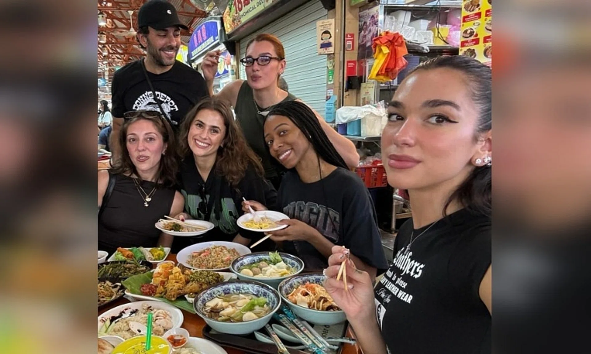 Dua Lipa (right) posted a photo of herself and her crew, as well as the local dishes they tucked into, on social media on Nov 6.