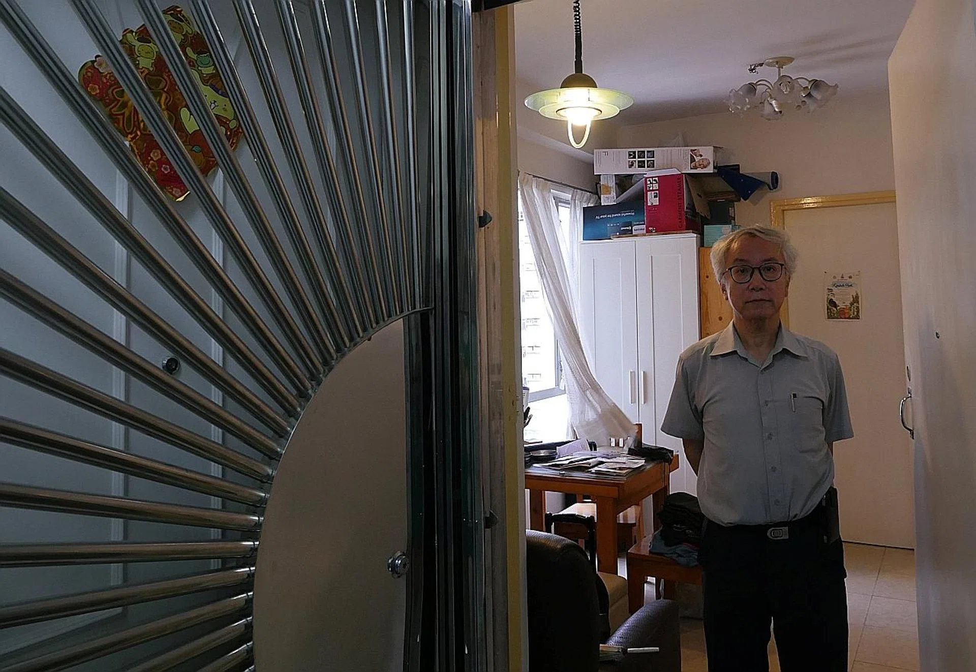 Landlord Ng Goon-lau in the apartment where two people died. 