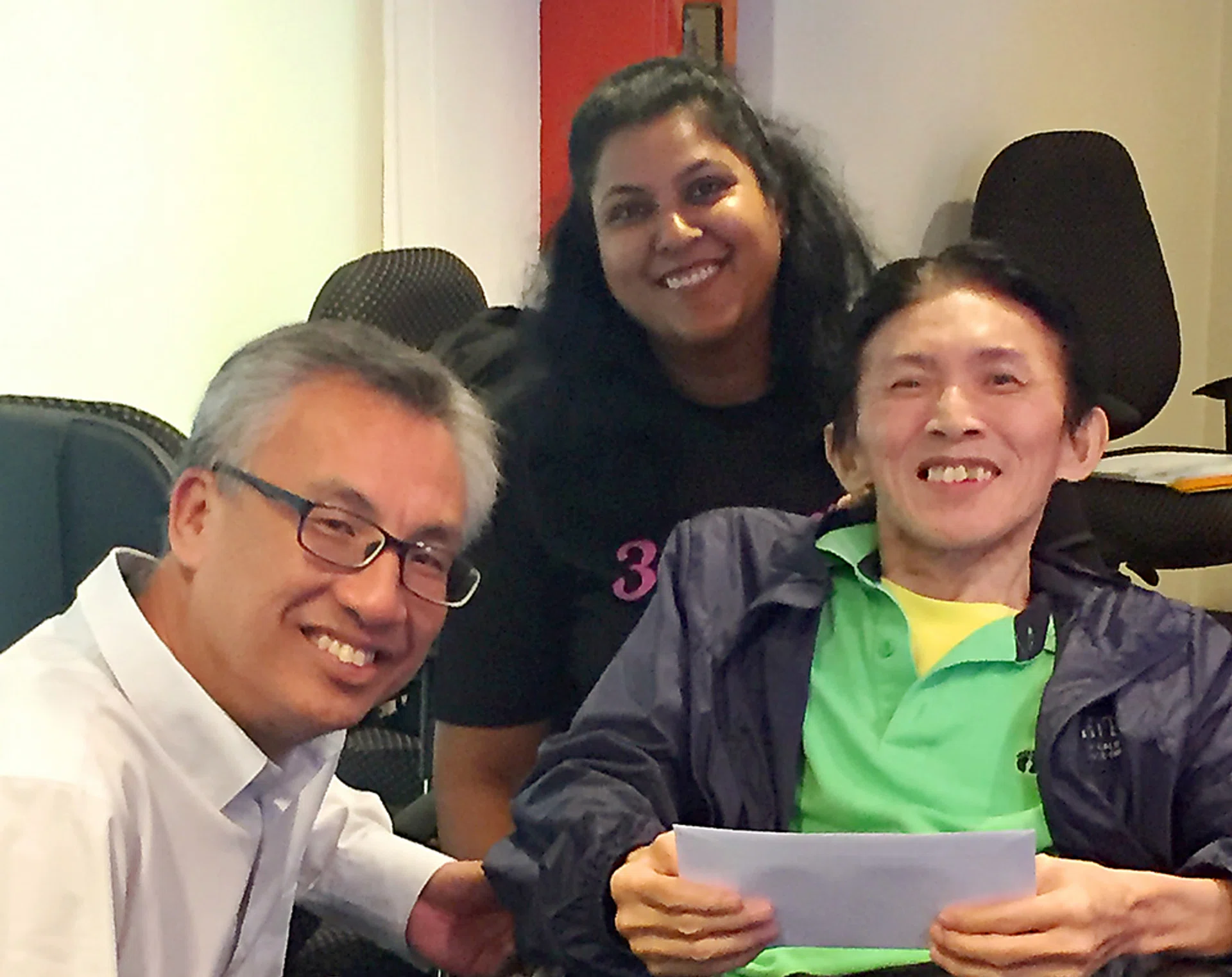 BIM Studio Manager Timothy Ang, 61, (right), received a cheque on behalf of the Disabled People's Association from Mr Yong Fook Chyi, director (corporate services) of Tote Board. Looking on is 
Advocacy Consultant Asha Karen. 