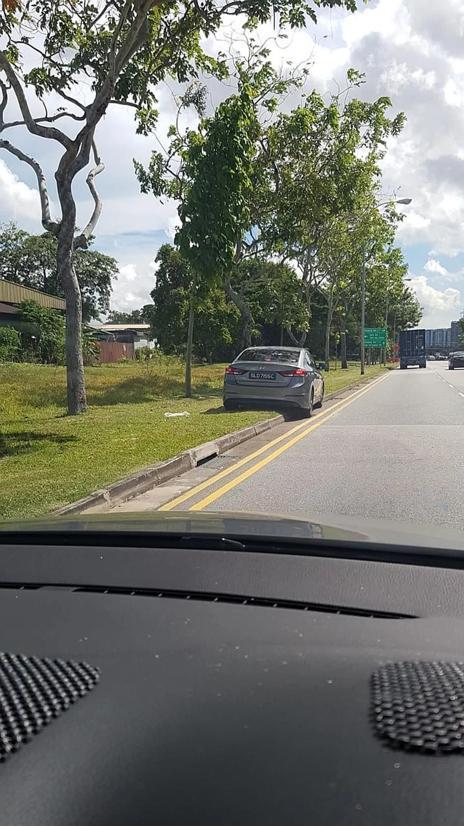 The grey car had mounted the kerb. 