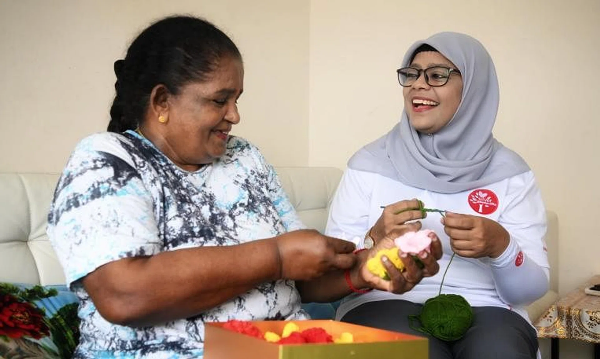 Silver Generation Ambassador Rasul Fathima Ahmad (right) visiting Madam Nair Lachmy Govinda Nair, 73, who lives alone.