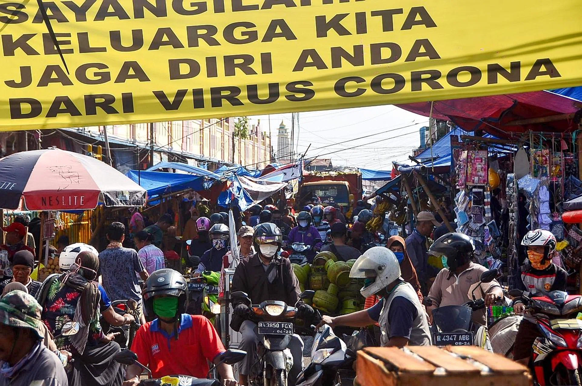 Indonesians at a traditional market in Bekasi, West Java, ignoring the physical distancing policy issued by the government. 