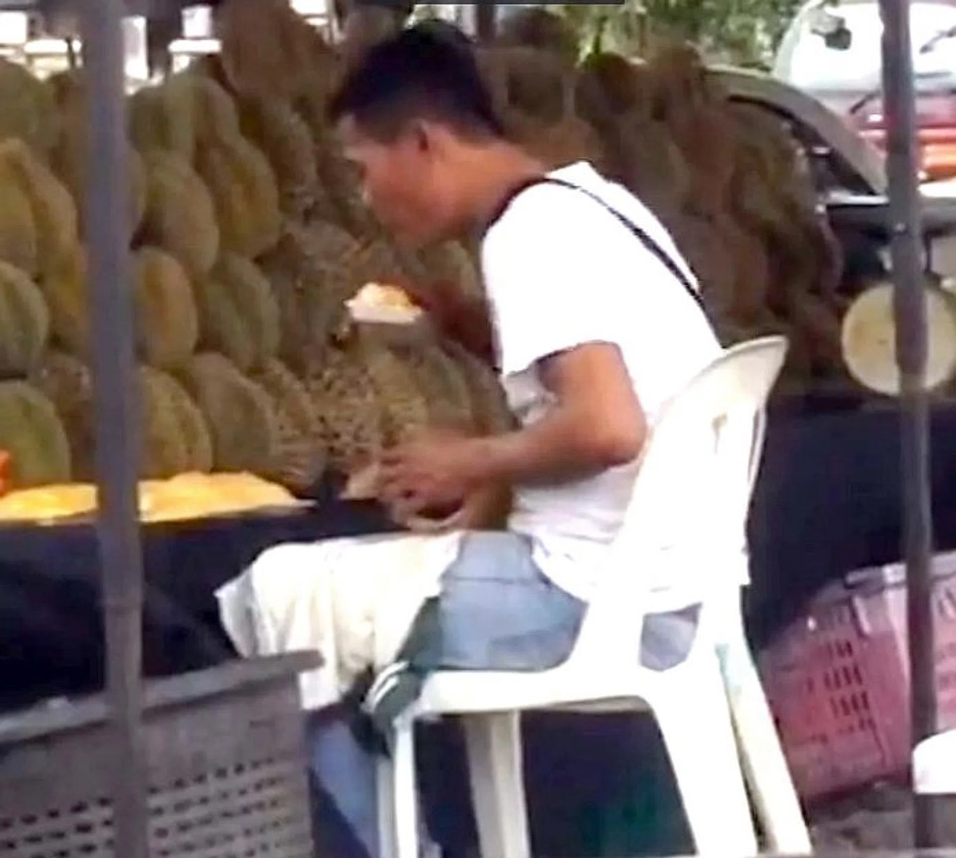 VIRAL: The clip shows the man making a jerking head movement over the exposed durian.