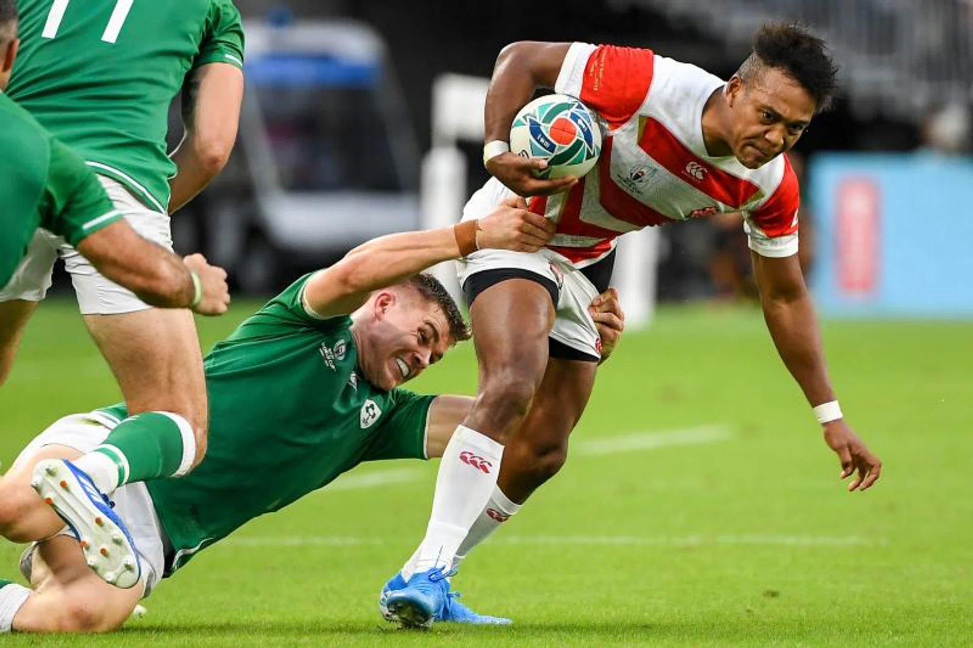 Japan's Kotaro Matsushima (right) is tackled by Ireland's wing Jacob Stockdale.
