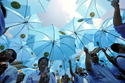 Workers' Party supporters taking shelter under a sea of blue umbrellas at Admiralty Secondary School, a nomination centre for the 2011 General Election.