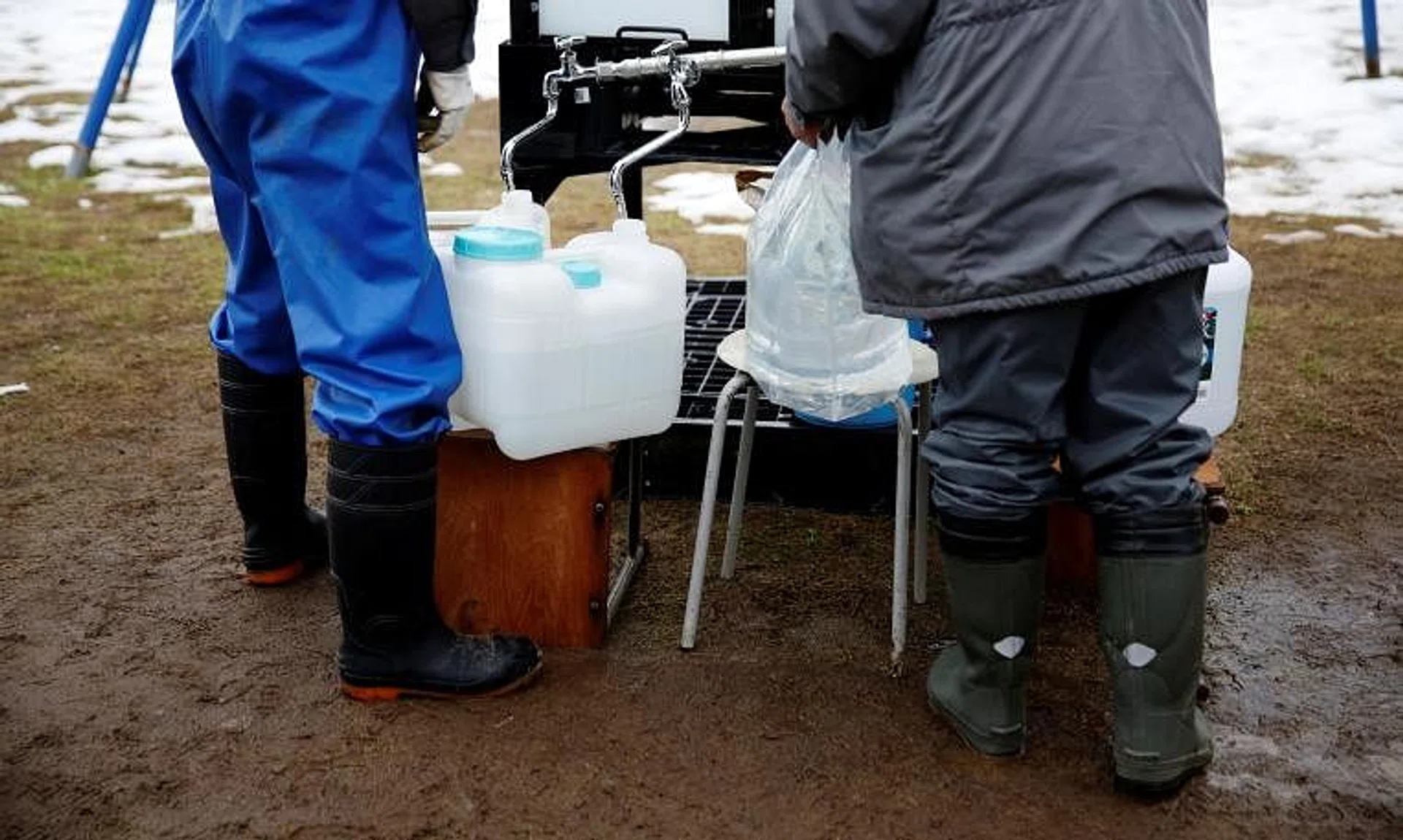 Locals filling up bottles from the communal water tank for Noto earthquake survivors in Suzu, Ishikawa prefecture, Japan, on Jan 30. 