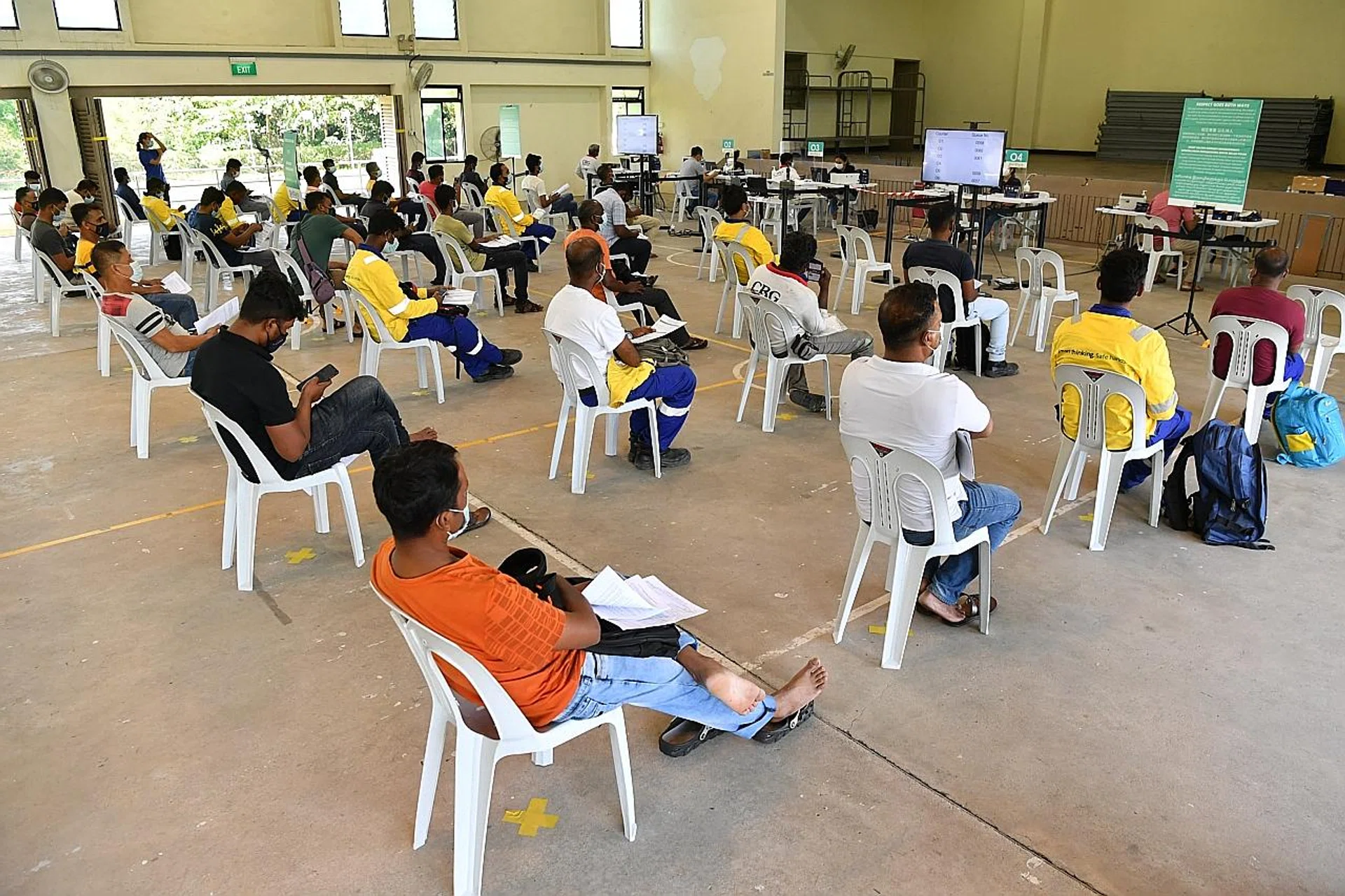 Migrant workers at the observation area after their Covid-19 vaccinations at the newly set-up Seletar Vaccination Centre. 