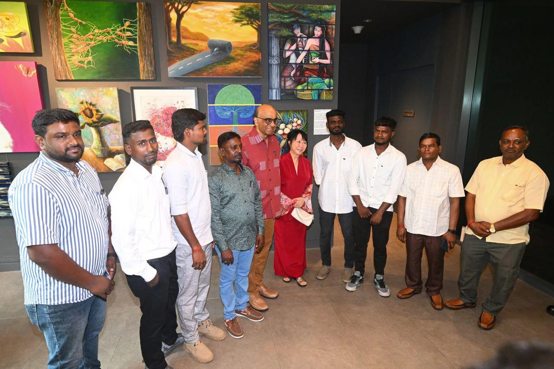 President Tharman Shanmugaratnam and his spouse, Ms Jane Ittogi (both centre), with the workers involved in the Tanjong Katong sinkhole rescue at the Istana open house on Aug 3.