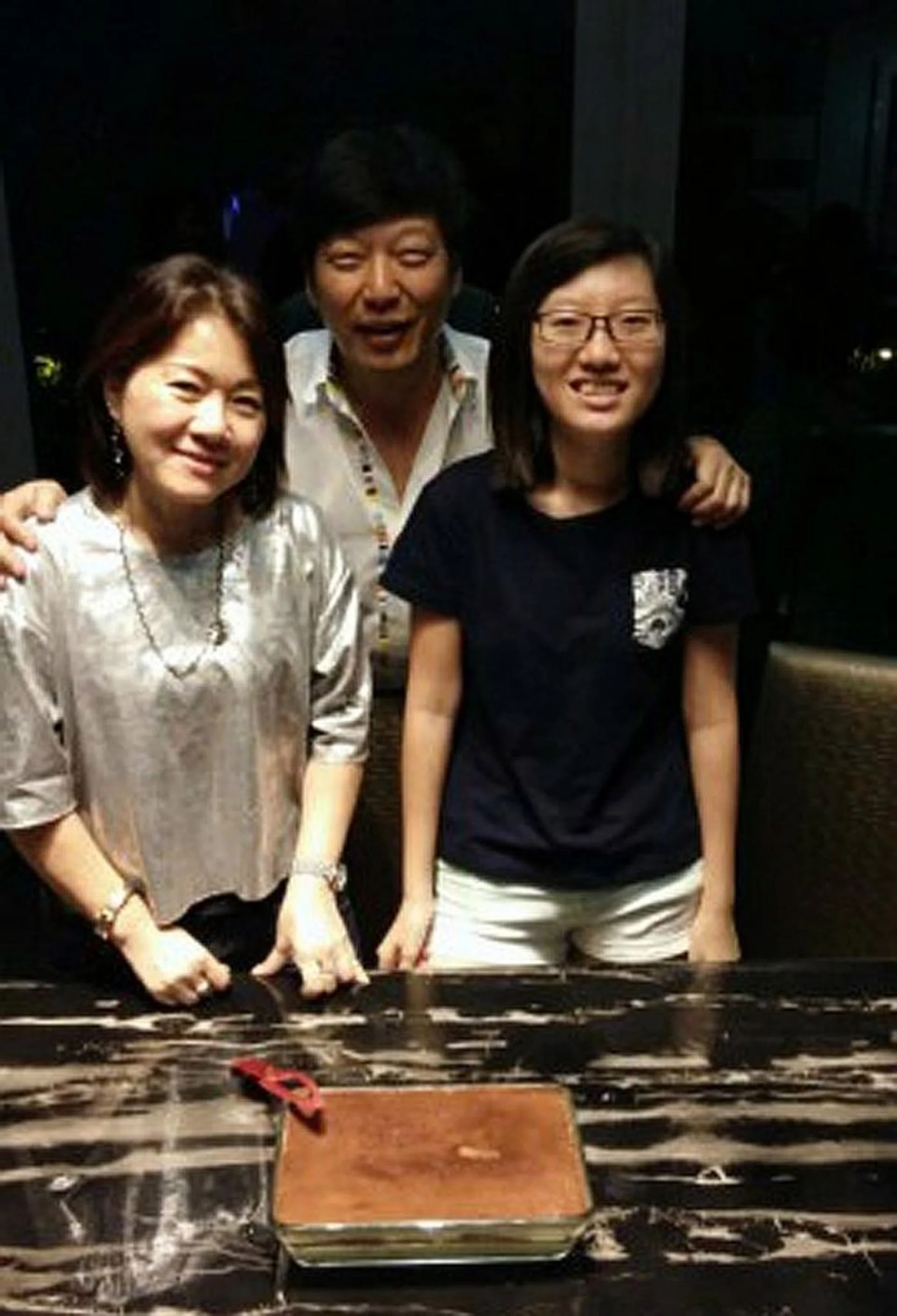 LOSS: Mr Robin Poon Joo Kim with his wife Yep Lay Choo and their daughter Kimberly Poon Hui Yin.