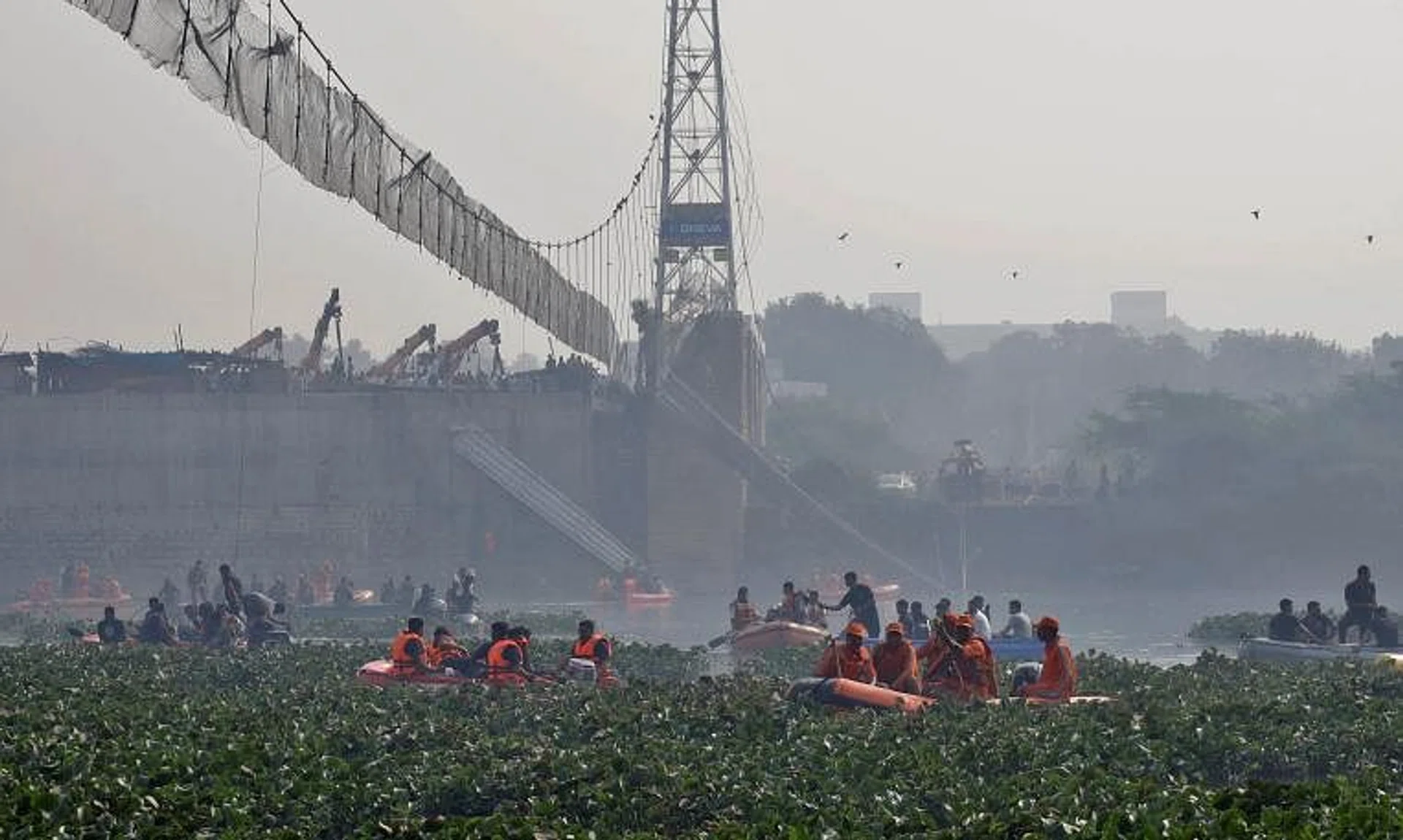 Rescuers search for survivors after the collapse of the suspension bridge in Gujarat, on Oct 31, 2022.