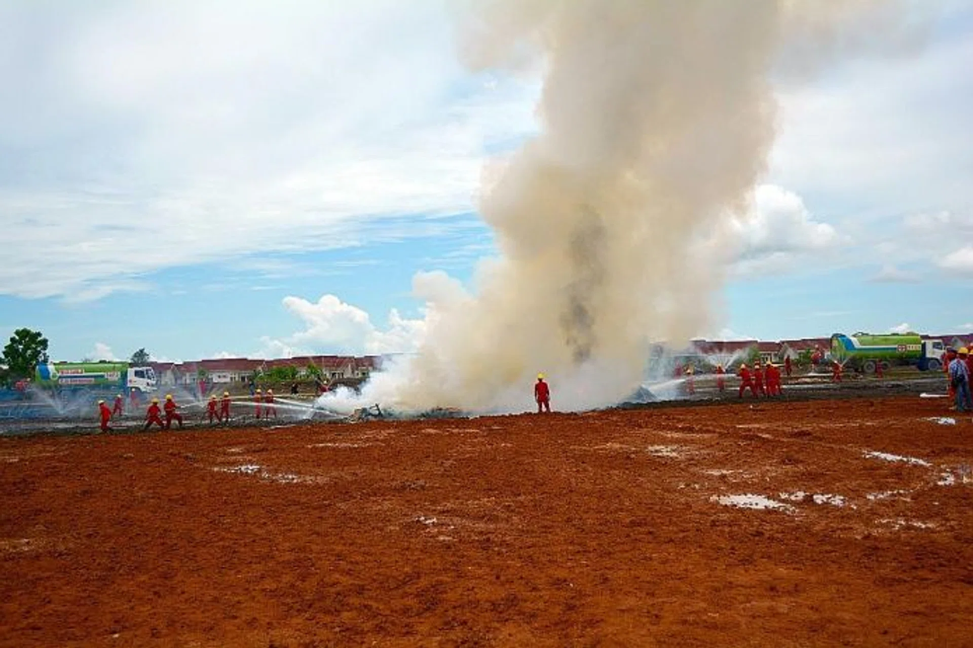 TRIAL RUN: Firefighters putting out fires during a demonstration at one of Asia Pulp & Paper's factories at Ogan Komering Ilir, Sumatra.