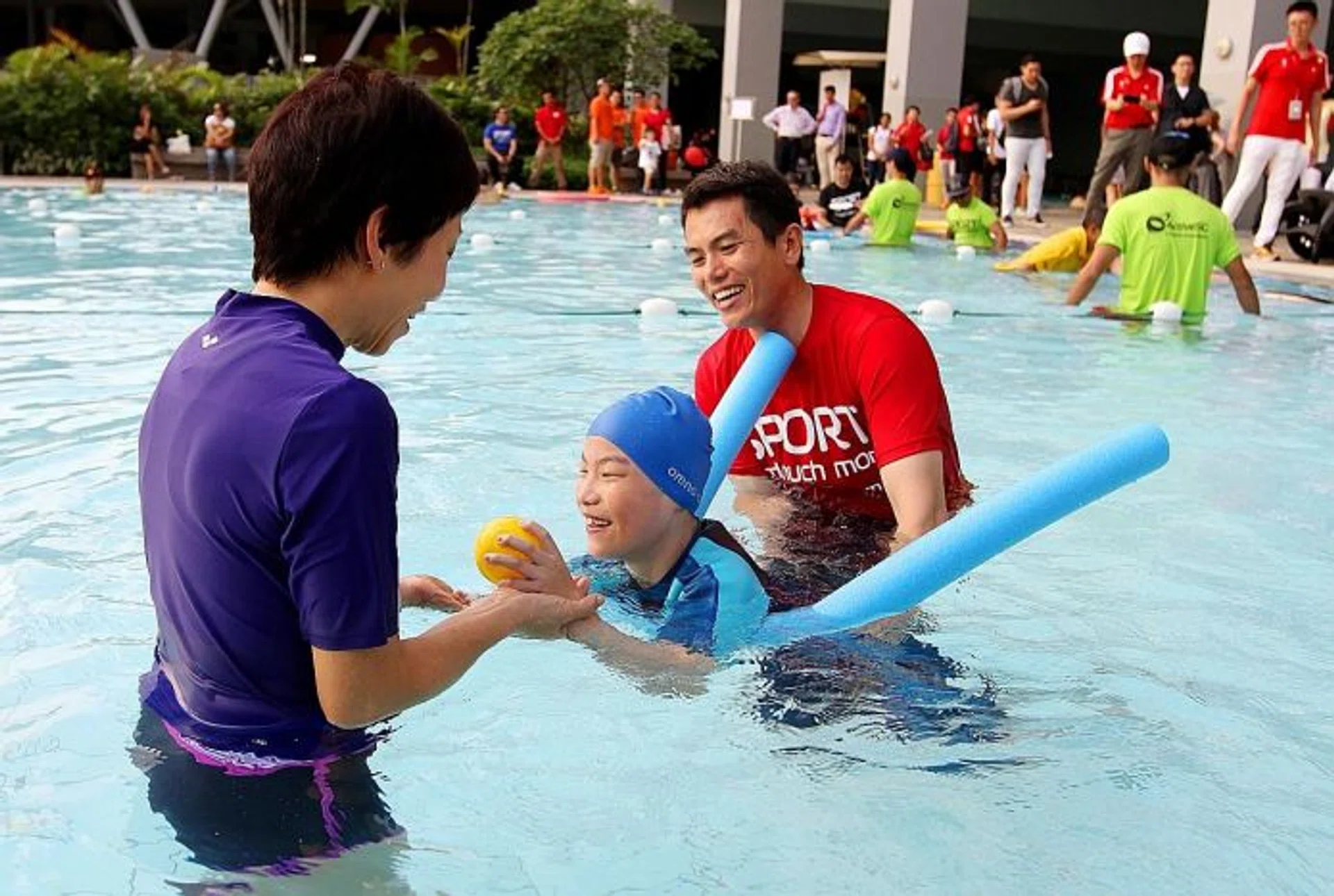 BUILDING TOWARDS AN ALL-INLCUSIVE SOCIETY: Minister for Culture, Community and Youth Grace Fu (in purple) interacting with Teo Choon Khang (centre), who has cerebral palsy, and swim coach Danny Ong at the ActiveSG Sengkang Sports Centre, which is the first Centre of Expertise for Disability Sports.  
