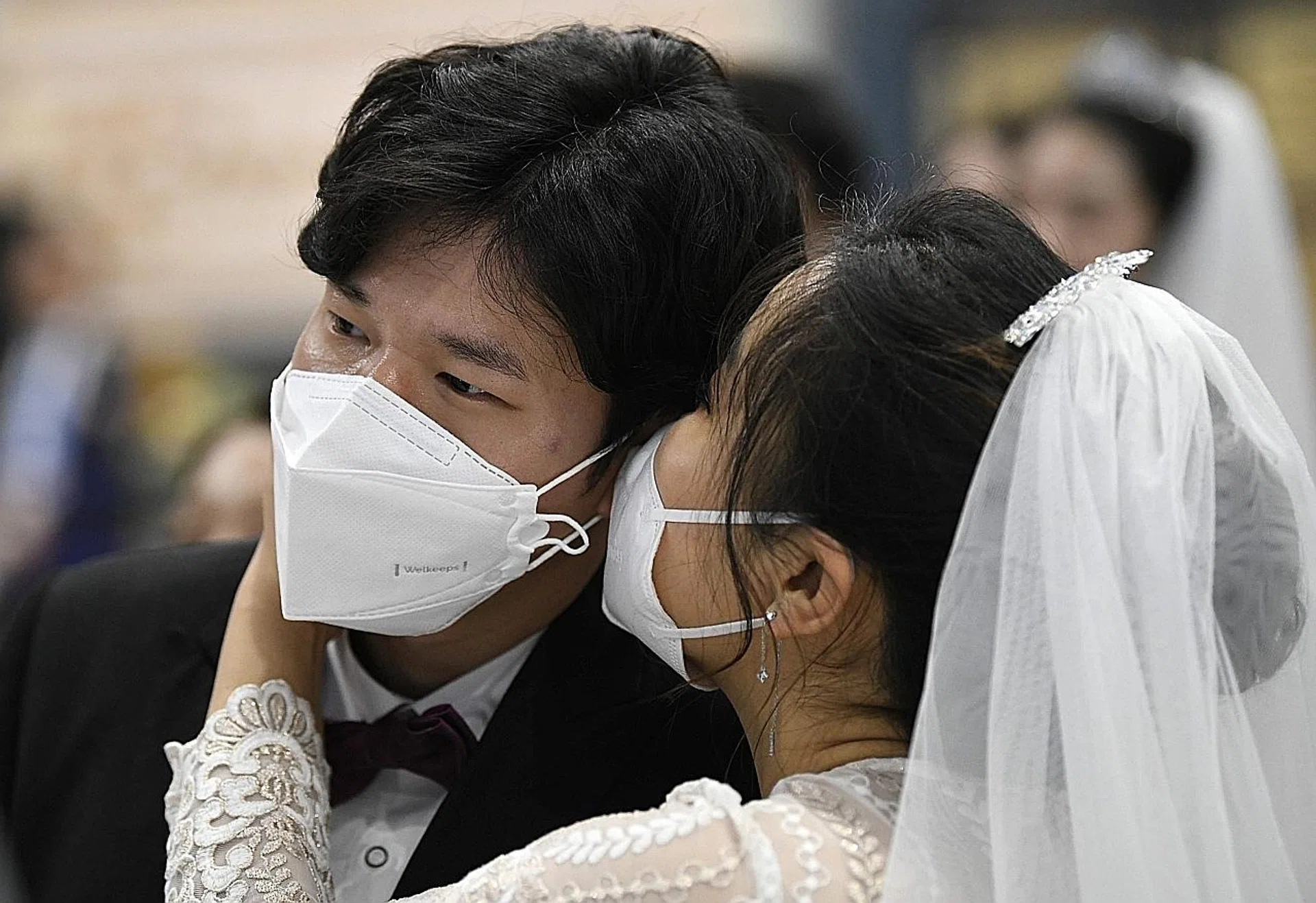 A couple attending a mass wedding ceremony in South Korea in February. 