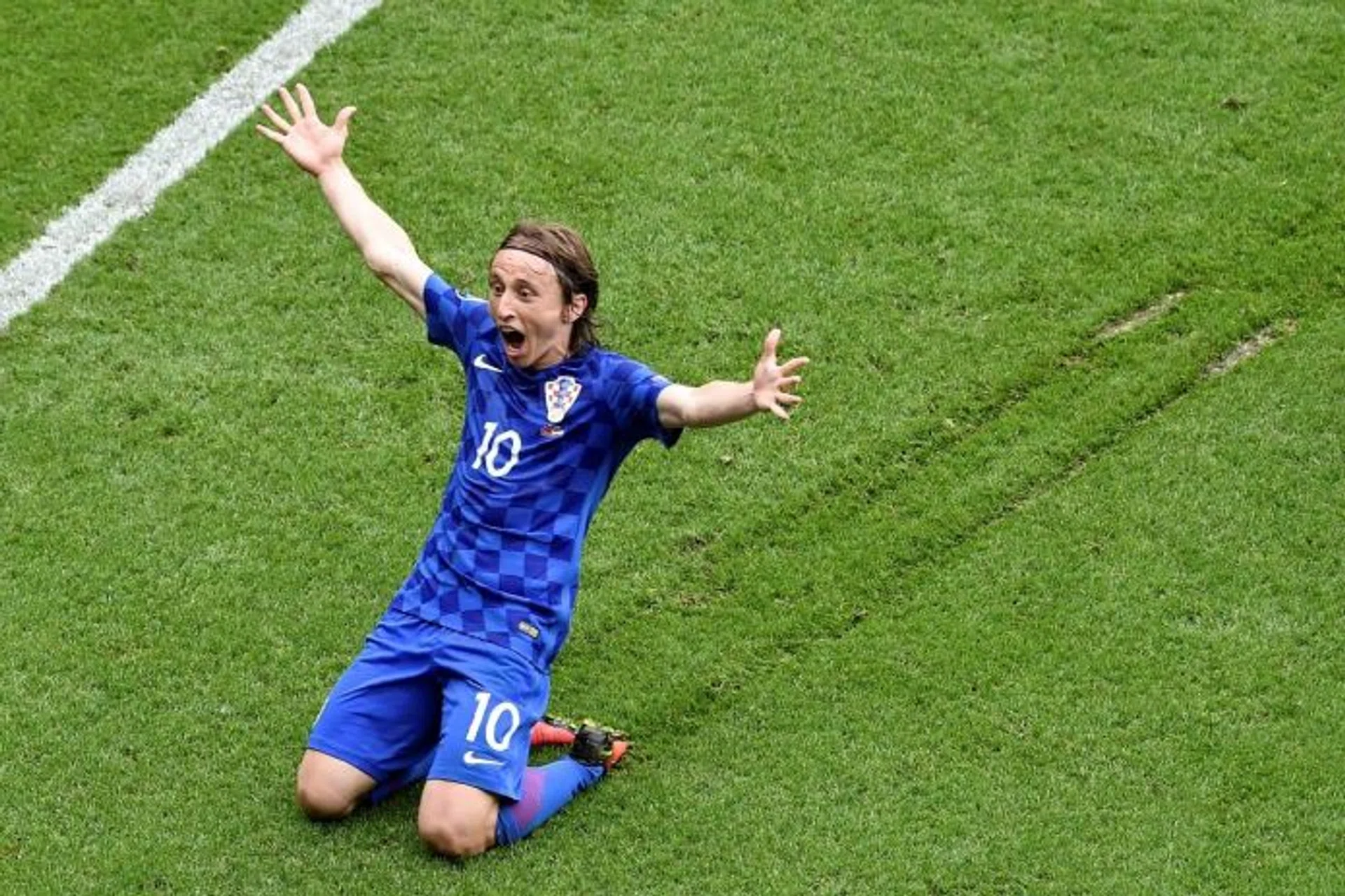 TRAIL BLAZER: Croatia's Luka Modric sliding on the pitch in celebration after scoring the superb volley off a half-cleared ball.