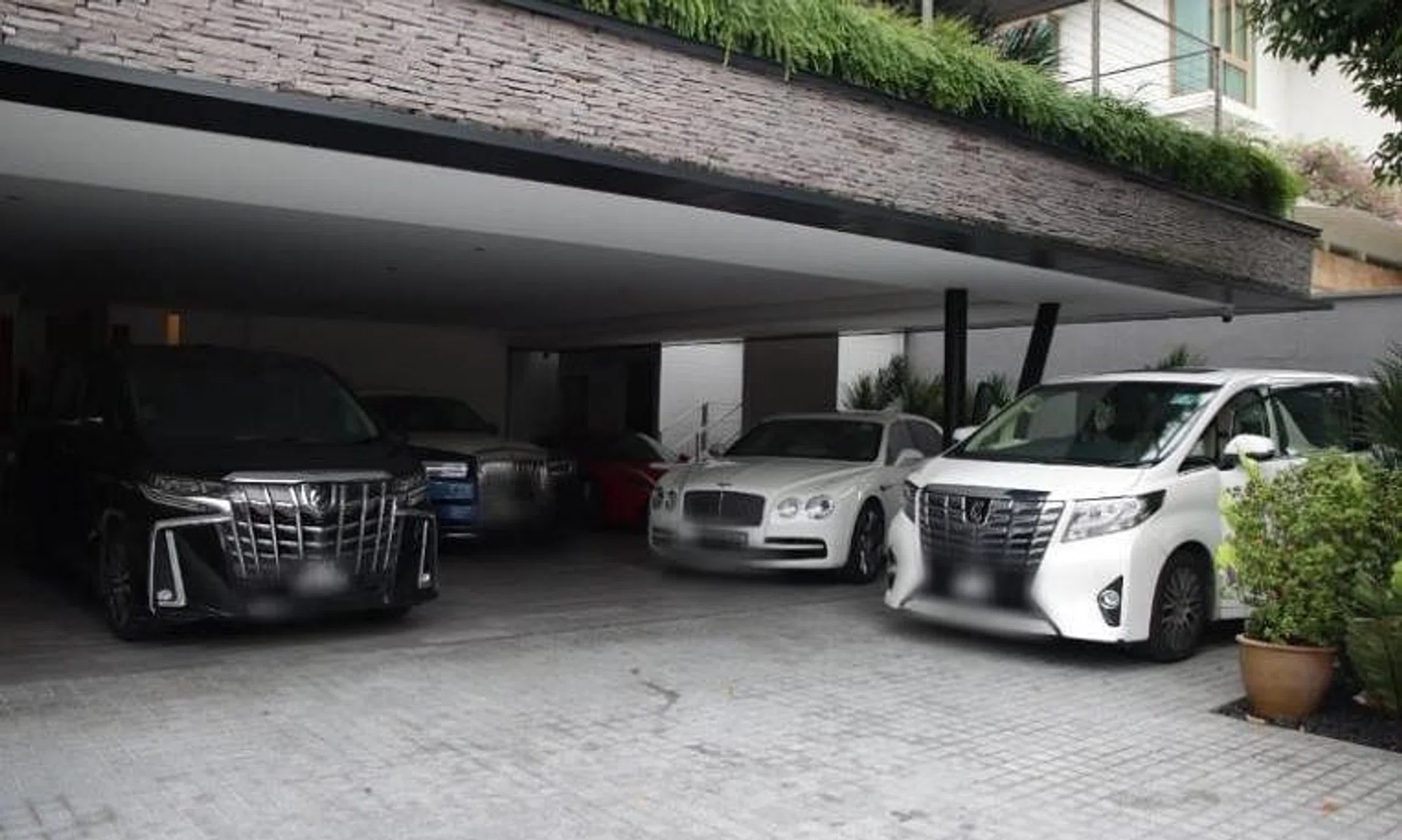 The group allegedly snapped up good class bungalows, high-end condominiums and owned luxury cars, amassing about $1 billion worth of assets.