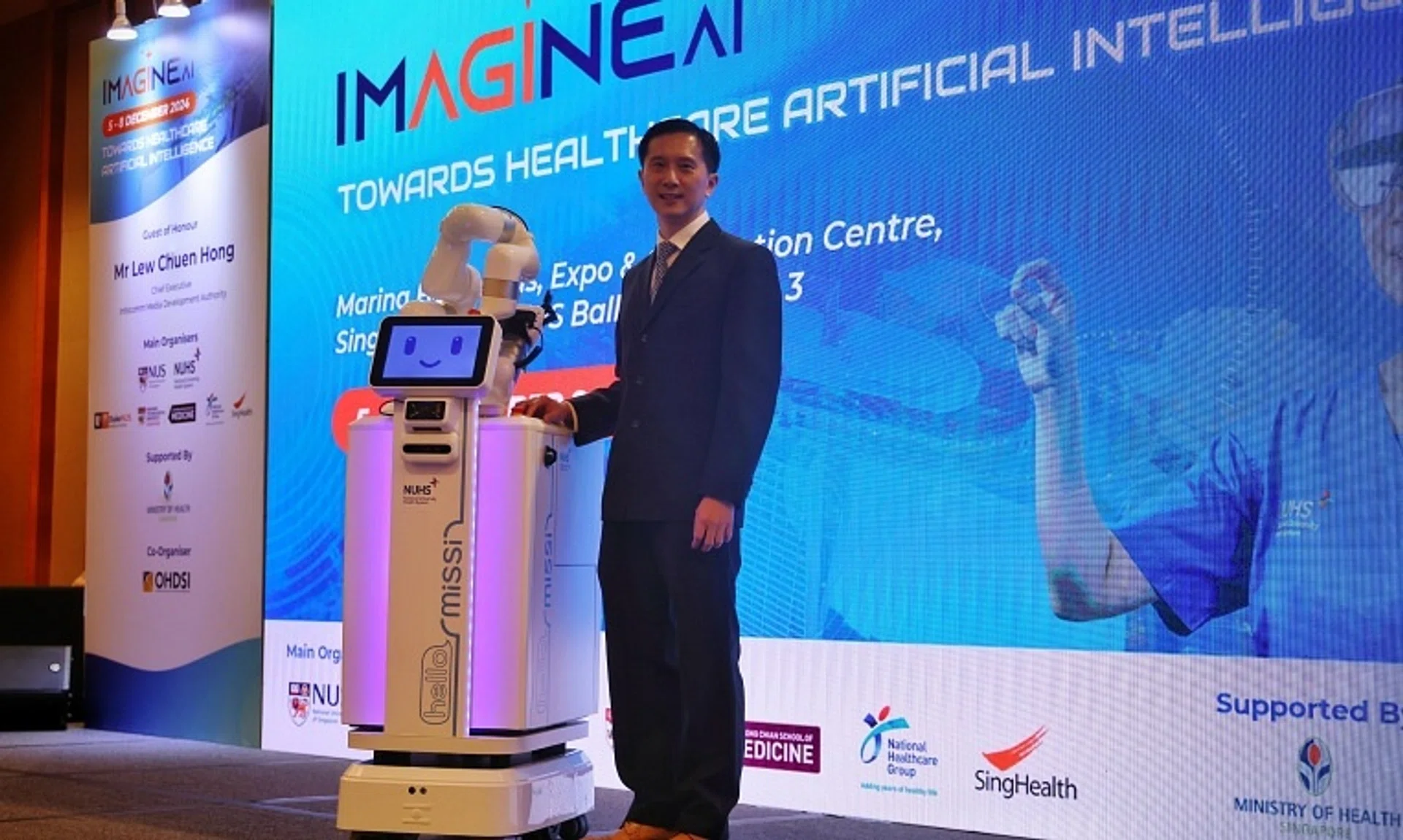 NUS Adjunct Professor Ngiam Kee Yuan posing with the Missi robot at the Imagine AI 2024 healthtech conference at Marina Bay Sands on Dec 5.