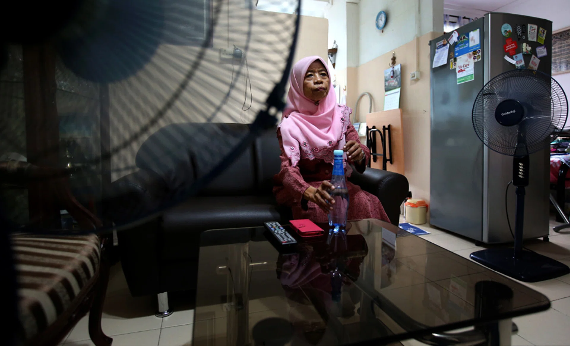 KEEPING COOL:  Madam Siti Buang tries to save money by not using her fan but these few months have been too hot for her not to.


