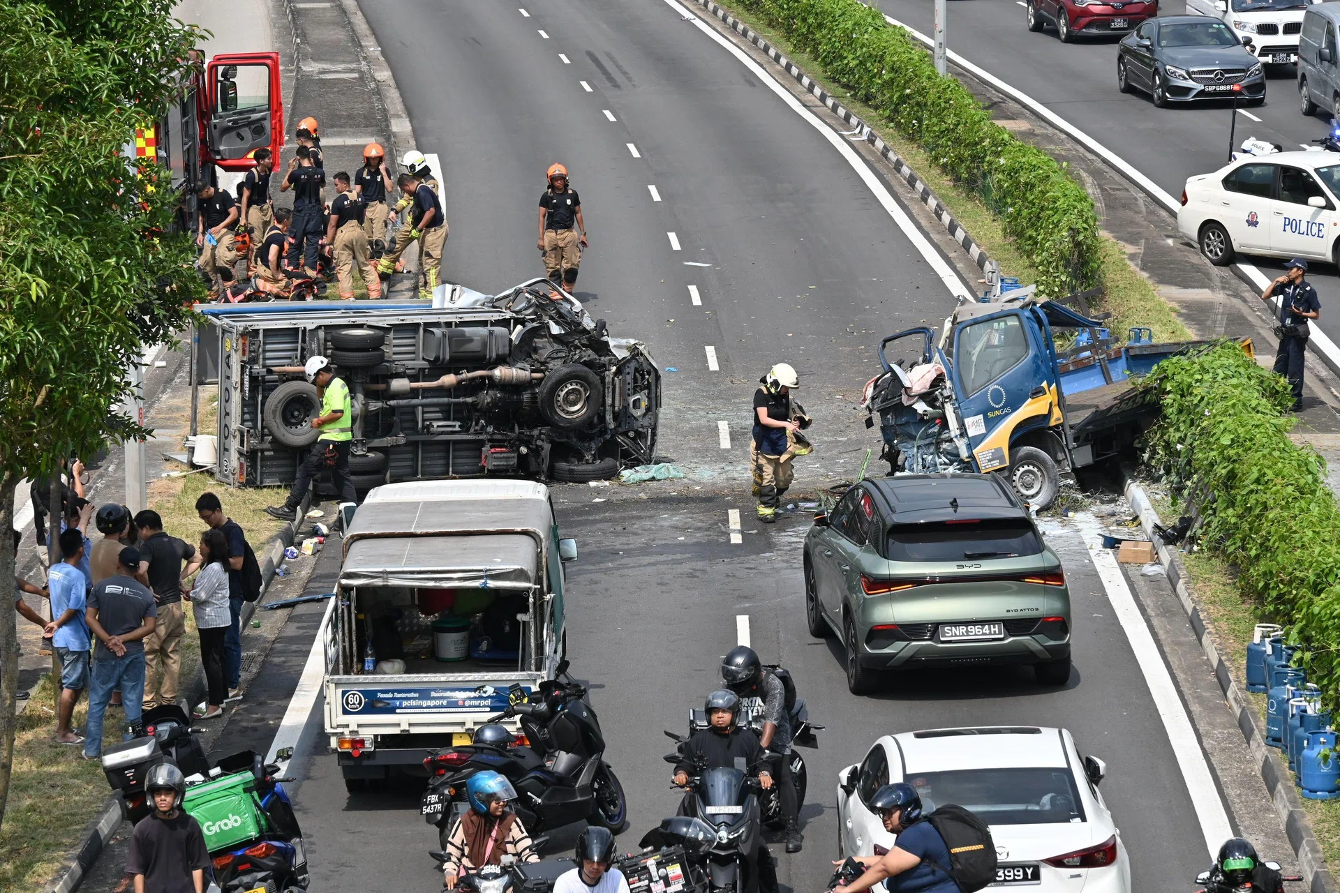 SCDF officers freed two people who were trapped in the driver’s seats of the lorries using hydraulic rescue equipment. 