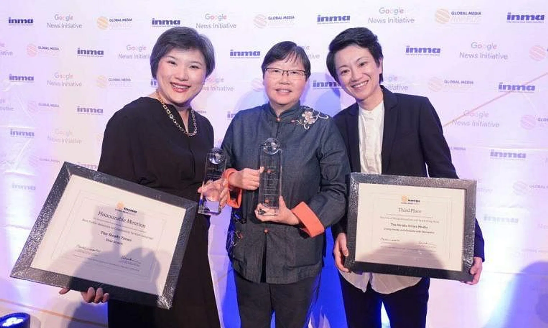 (From left) ST’s video editor E-von Yeung, ST Now editor Lee Yulin and audience growth editor Ng Kai Ling collecting the awards at the Harvard Club in New York City, on May 26.