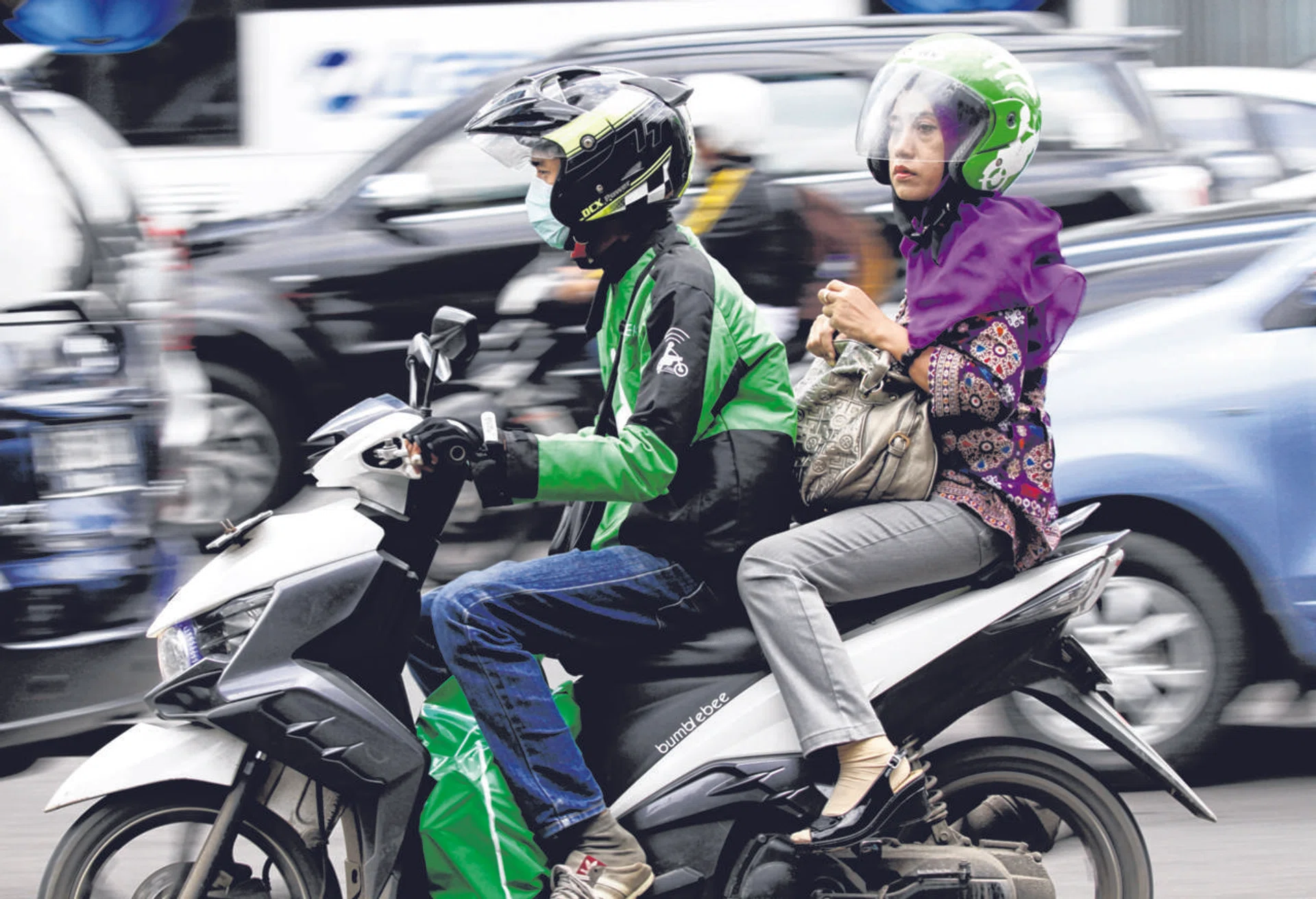 A woman using the Go-Jek ride-hailng service in Jakarta.