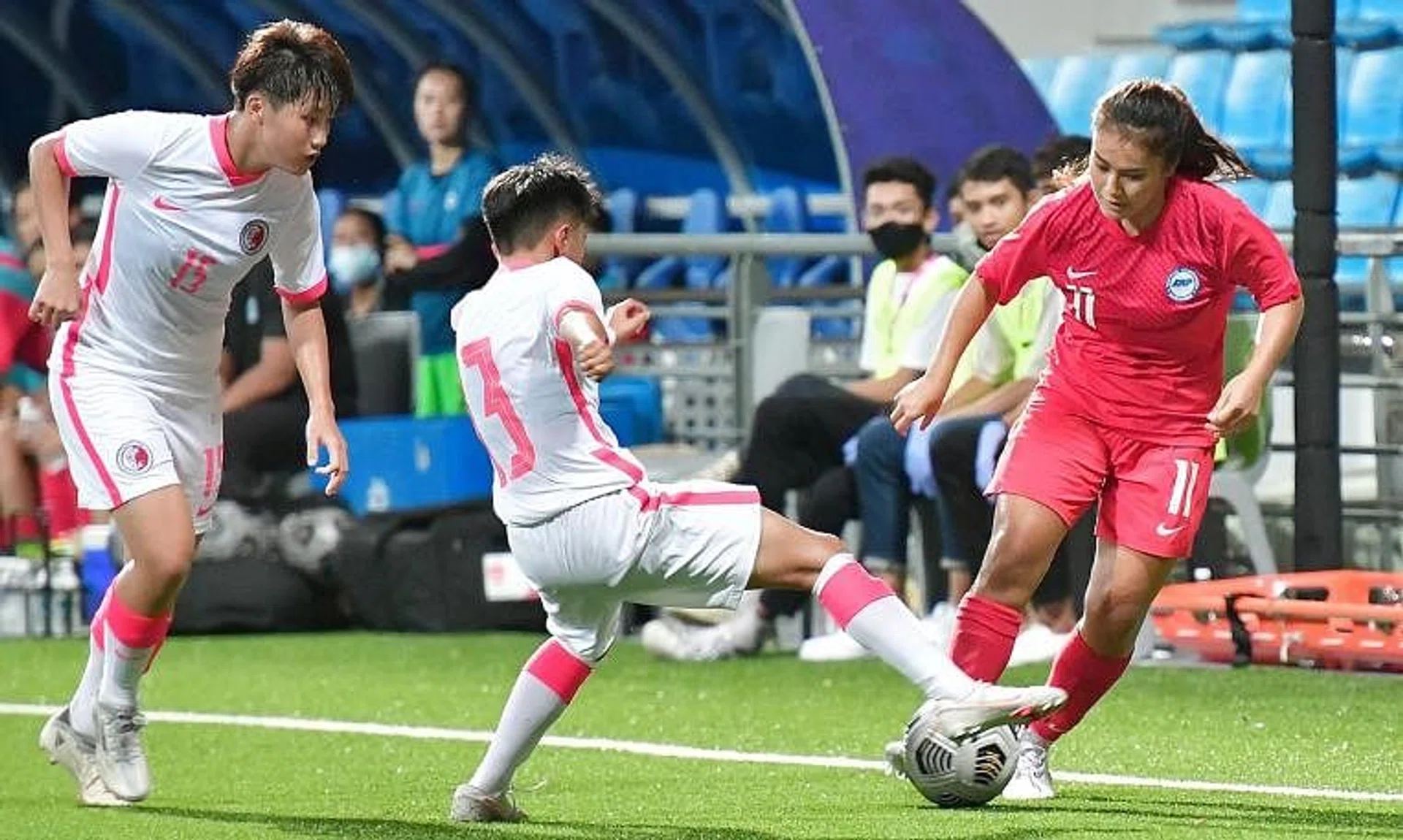 Singapore's Putri Nur Syaliza (right) defending against Hong Kong forward Tsang Lai Mae during their friendly match on June 23, 2022.