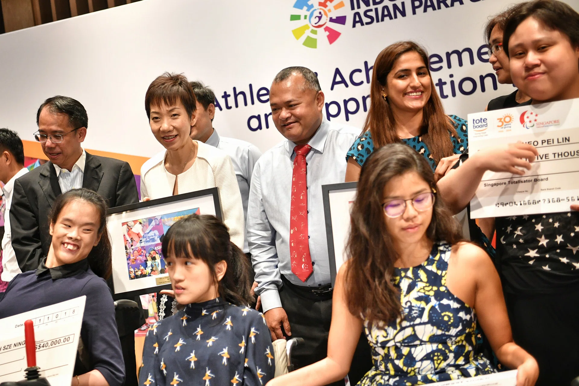 Minister Grace Fu (standing, second from left) with officials, guests and para-athletes at last night's Athletes' Achievement Awards. 