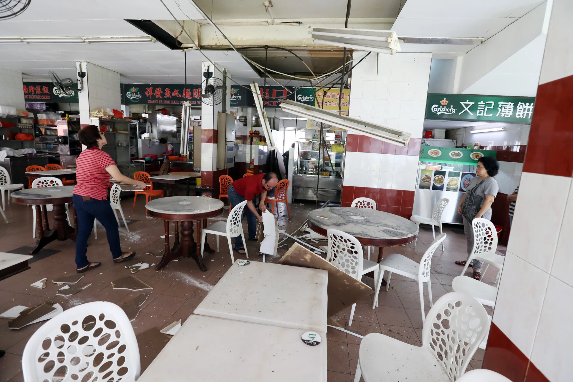 CRASH: Ceiling boards fell at lunch time at a Bukit Merah coffee shop yesterday, leaving debris (above) that was later cleared.