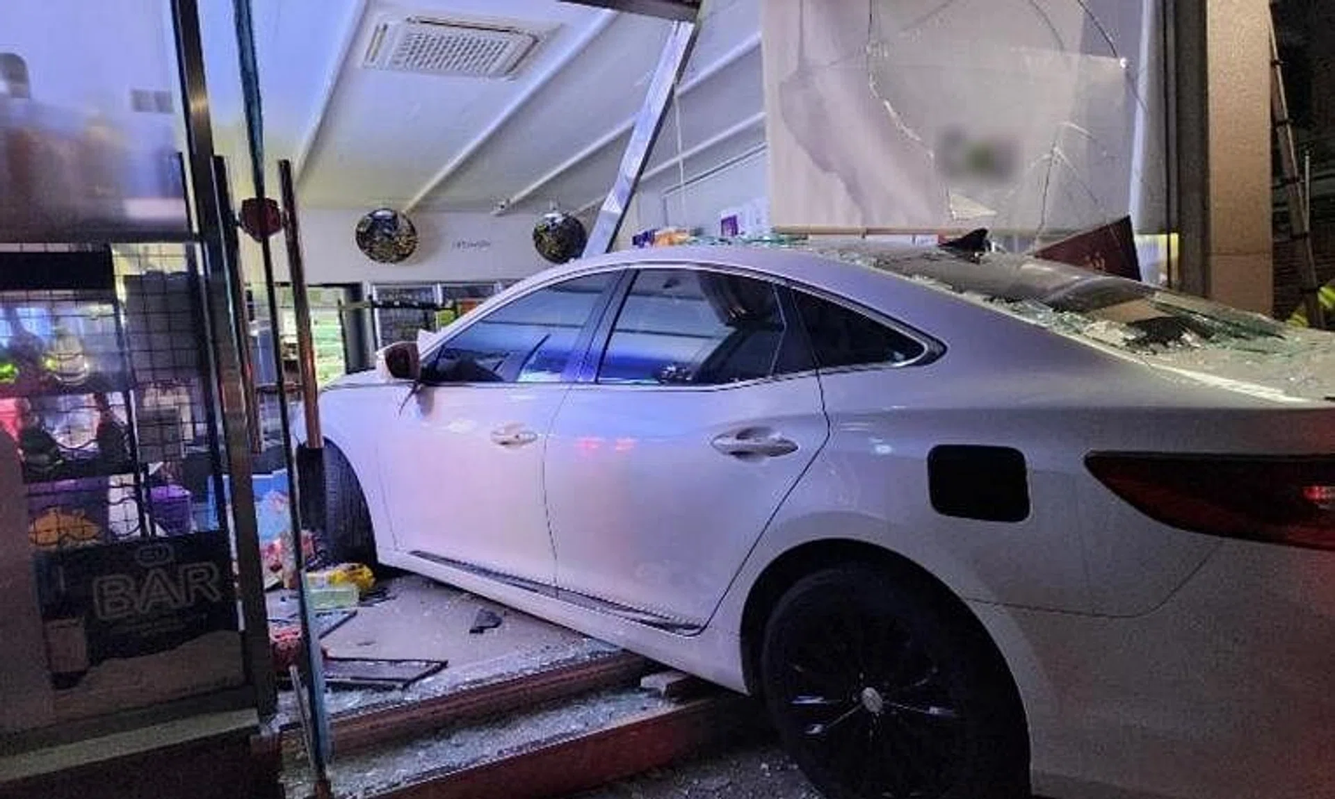 The driver slammed the car into the store in Geoje city, then rushed in and assaulted the owner.