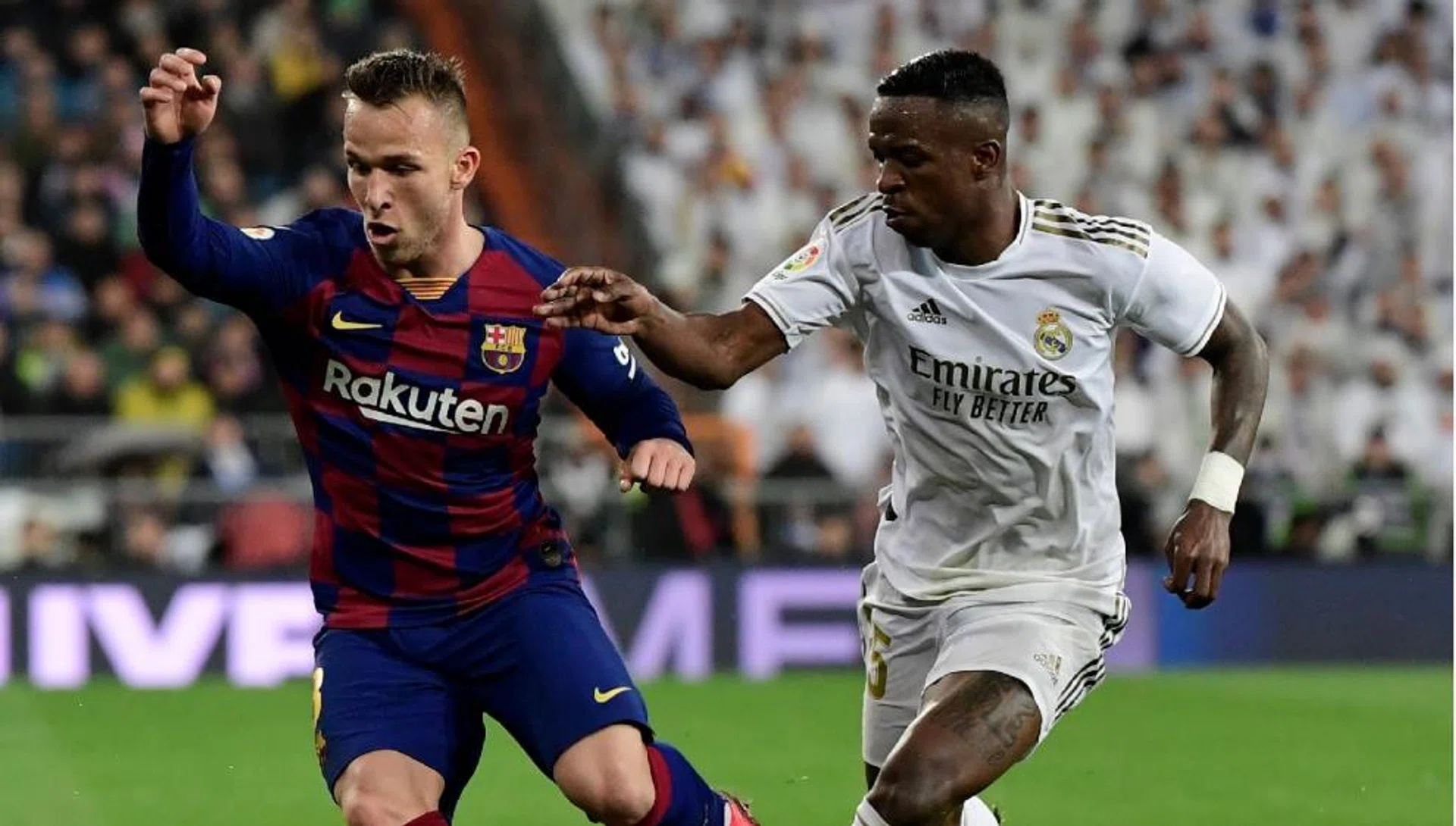 Barcelona midfielder Arthur Melo (left) couldn't stop Vinicius Junior's Real Madrid from winning 2-0 in El Clasico last month.