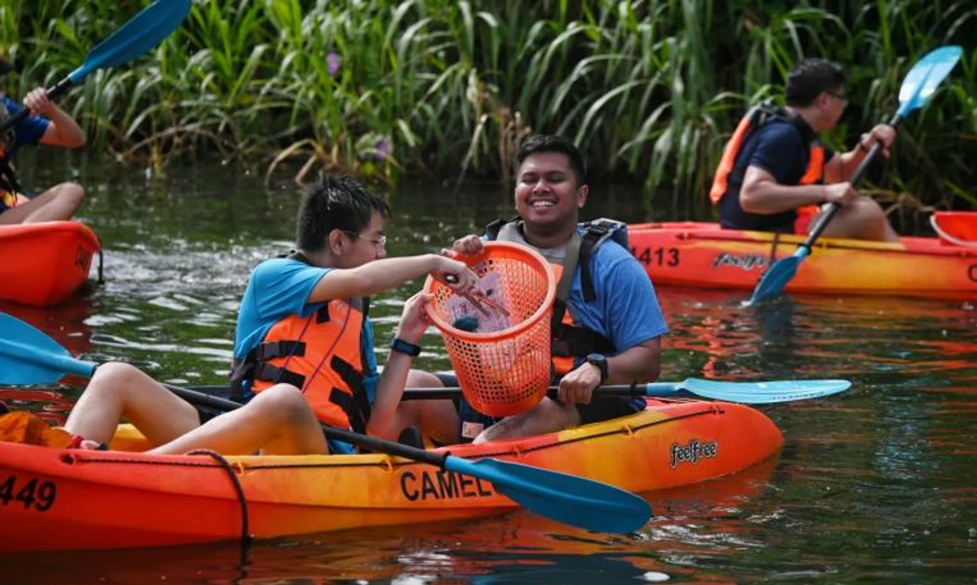 Singapore Children's Society beneficiaries in their kayaks clearing rubbish from Lower Seletar Reservoir on March 16, 2022.