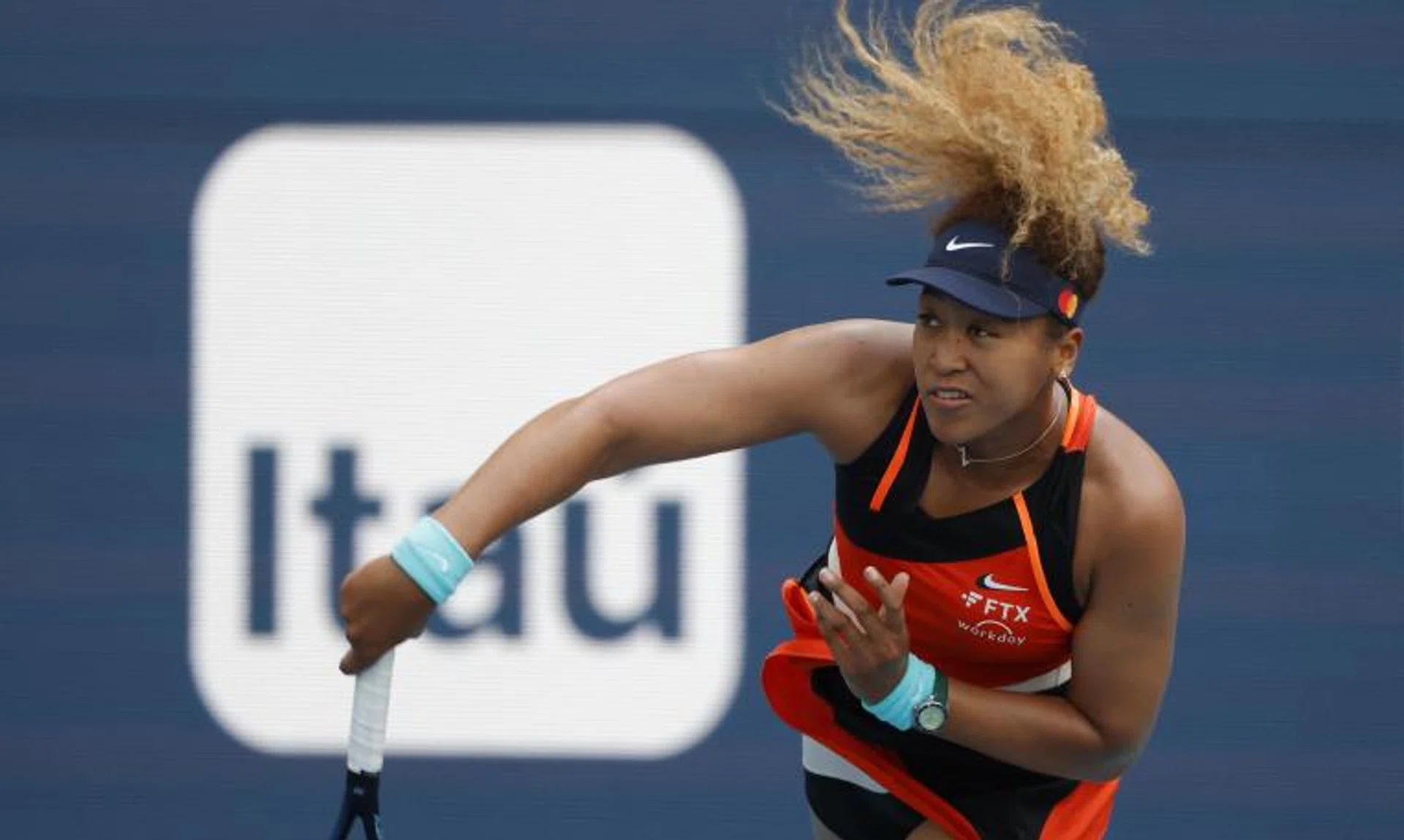 Naomi Osaka serves against Belinda Bencic at the Miami Open.
